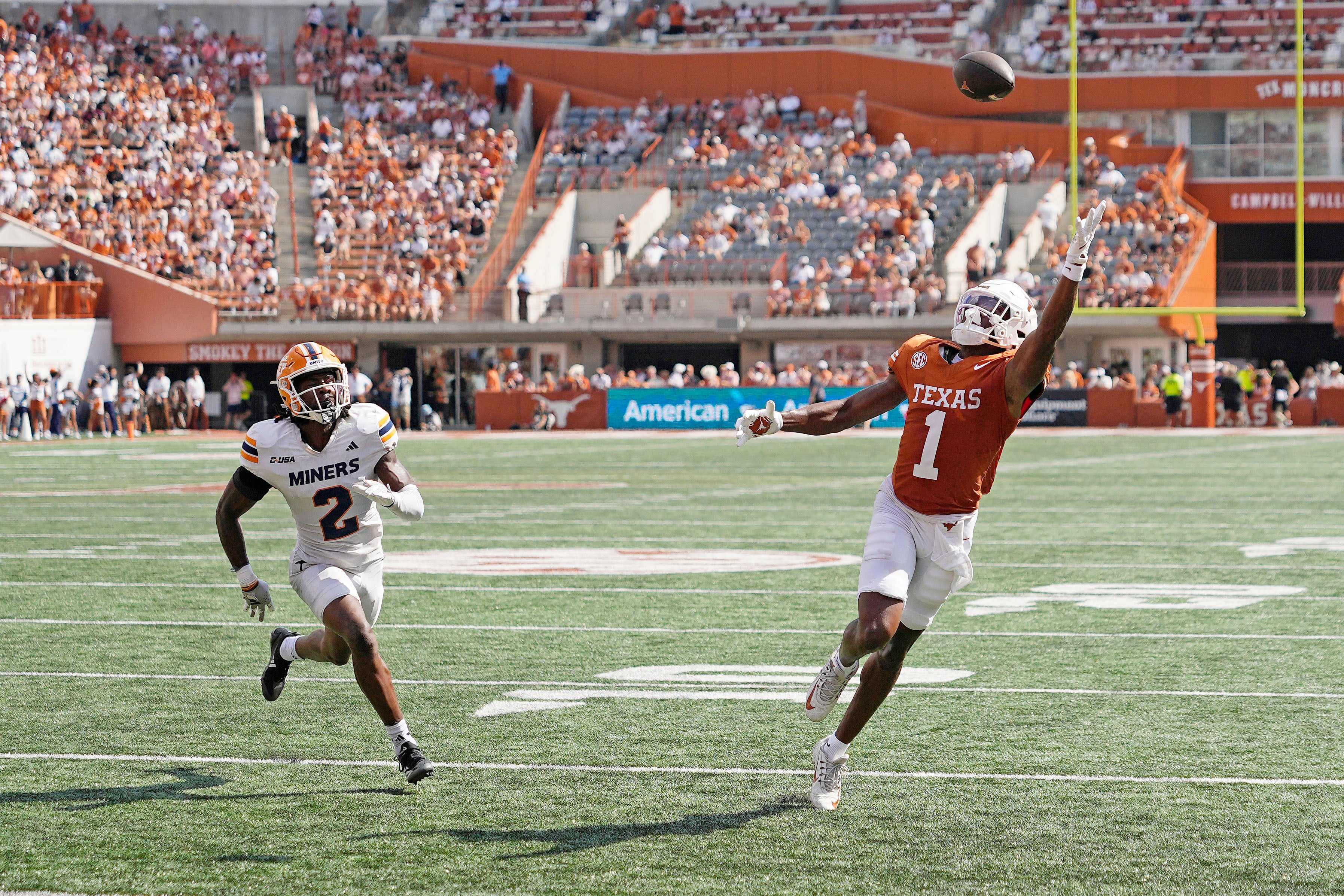 Sep 13, 2025; Austin, Texas, USA; Texas Longhorns wide receiver Ryan Wingo (1) reaches for a pass while defended by Texas El Paso Miners safety Xavier Smith (2) during the first half at Darrell K Royal-Texas Memorial Stadium.