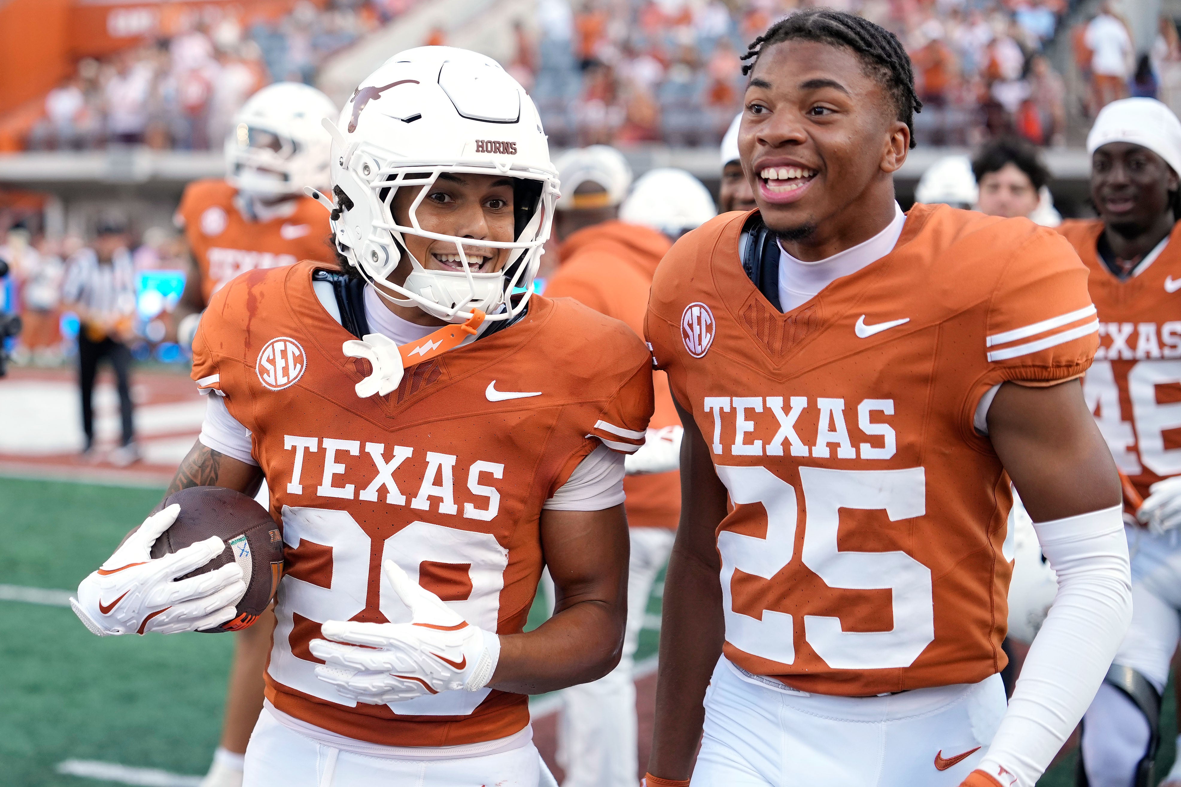 Sep 13, 2025; Austin, Texas, USA; Texas Longhorns defensive backs Graceson Littleton (29) and Caleb Chester (25) react after Littleton made an interception during the second half against the Texas El Paso Miners at Darrell K Royal-Texas Memorial Stadium.
