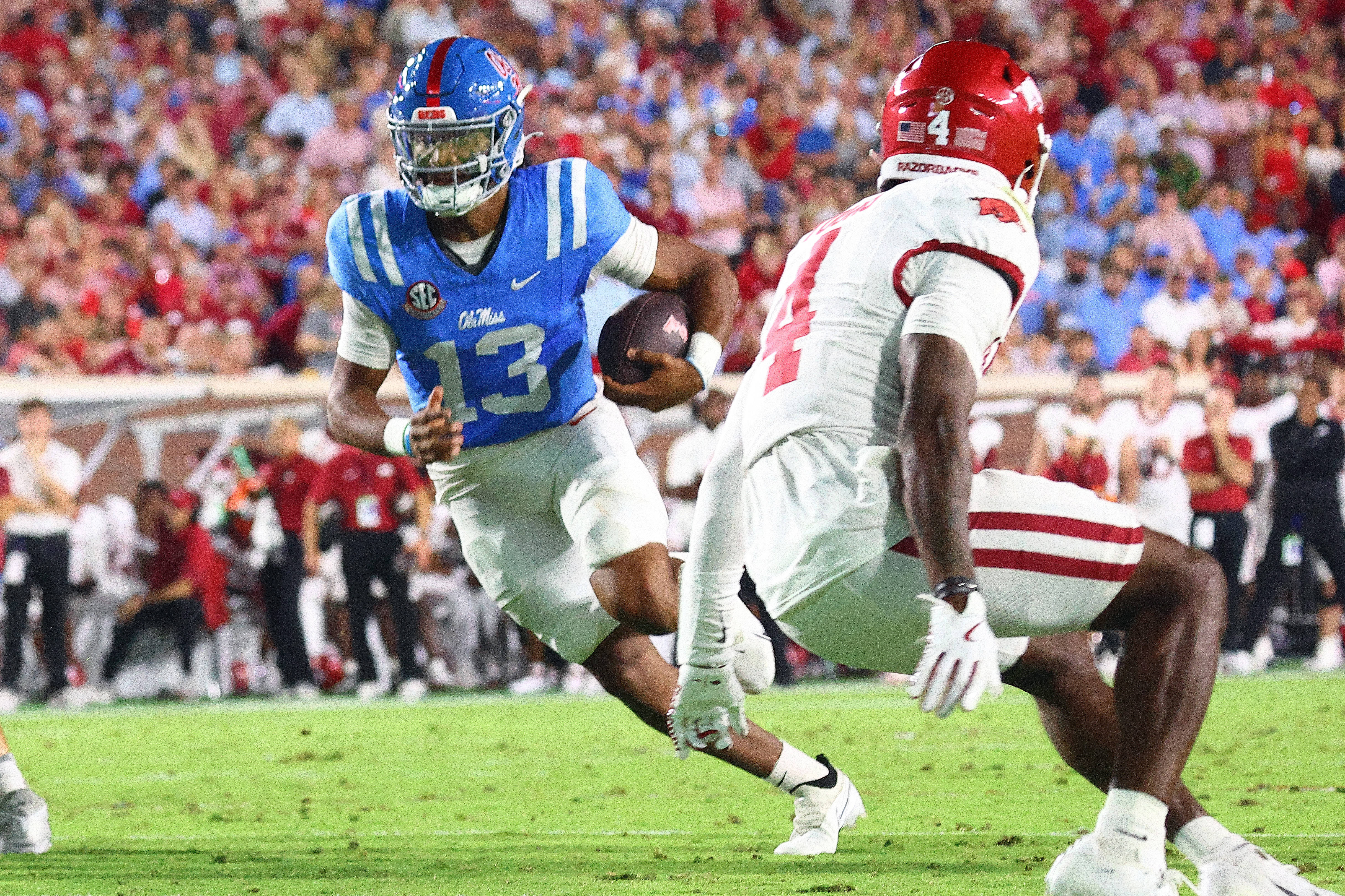 Sep 13, 2025; Oxford, Mississippi, USA; Mississippi Rebels quarterback Austin Simmons (13) runs the ball during the second quarter against the Arkansas Razorback at Vaught-Hemingway Stadium.