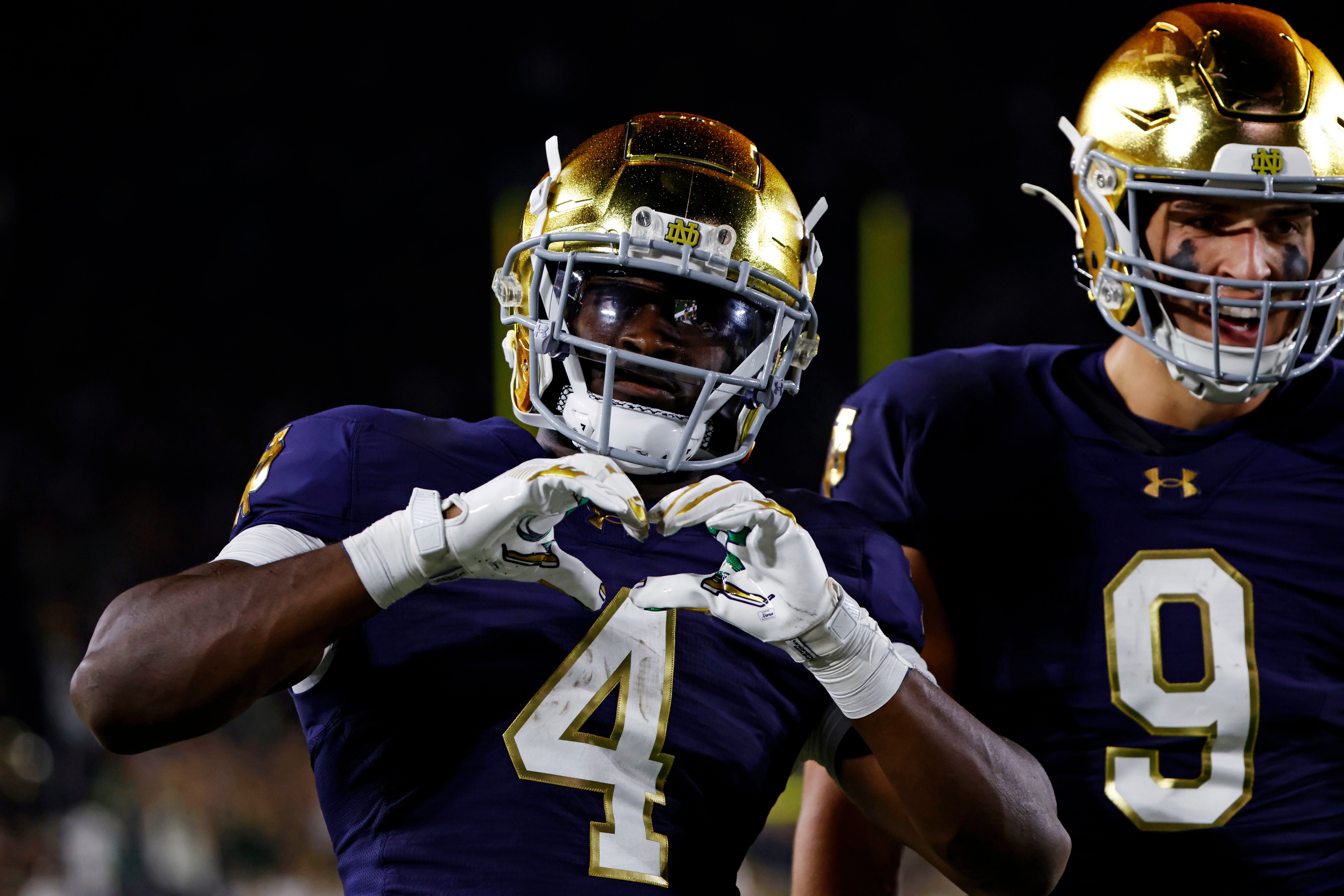 Sep 13, 2025; South Bend, Indiana, USA; Notre Dame Fighting Irish running back Jeremiyah Love (4) shares a heart with the fans during the second half against the Texas A&M Aggies at Notre Dame Stadium. Mandatory Credit: Michael Caterina-Imagn Images