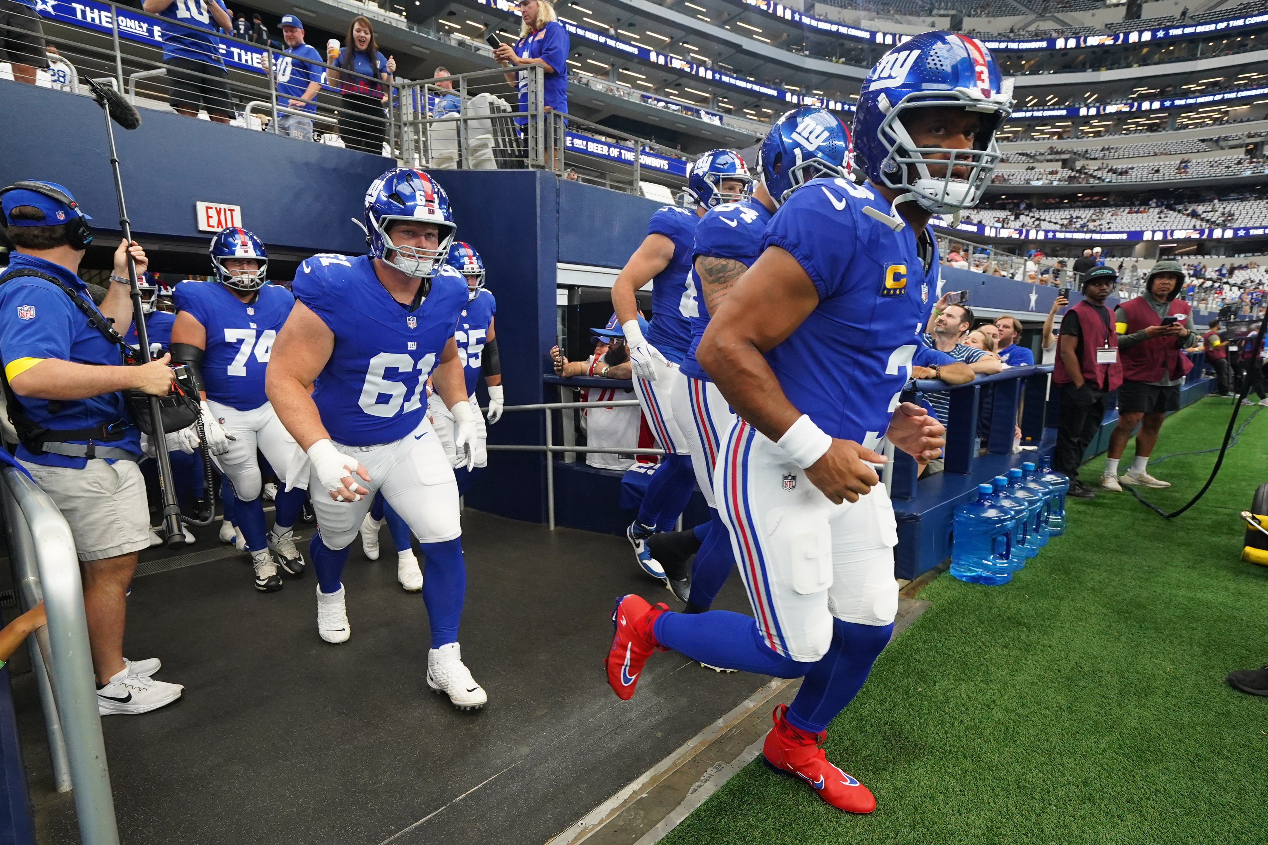 Sep 14, 2025; Arlington, Texas, USA; New York Giants quarterback Russell Wilson (3) runs onto the field for warmups before the game against the Dallas Cowboys at AT&T Stadium.