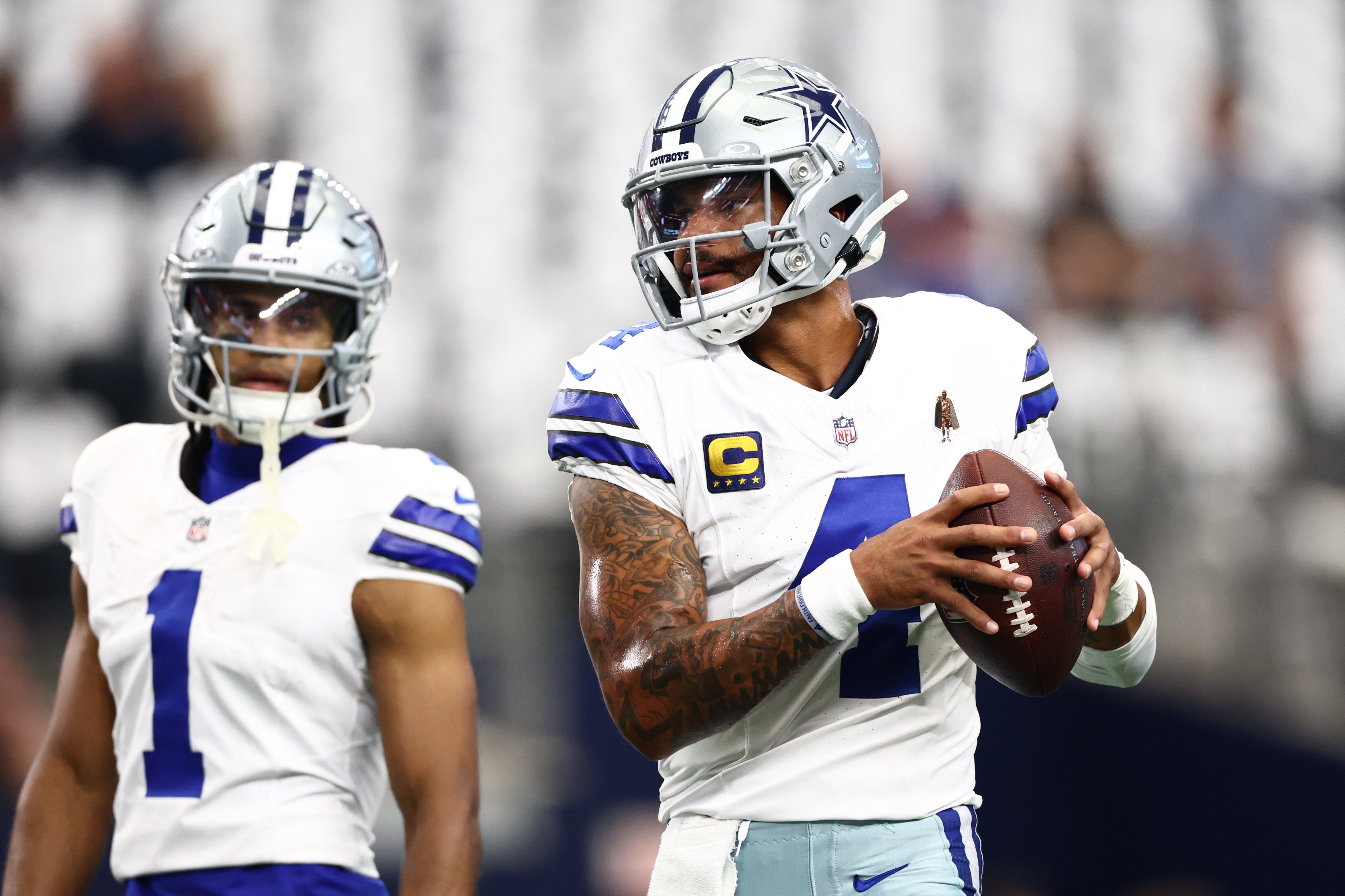 Dallas Cowboys quarterback Dak Prescott (4) during warmups as wide receiver Jalen Tolbert (1) looks on before the game against the New York Giants at AT&T Stadium.