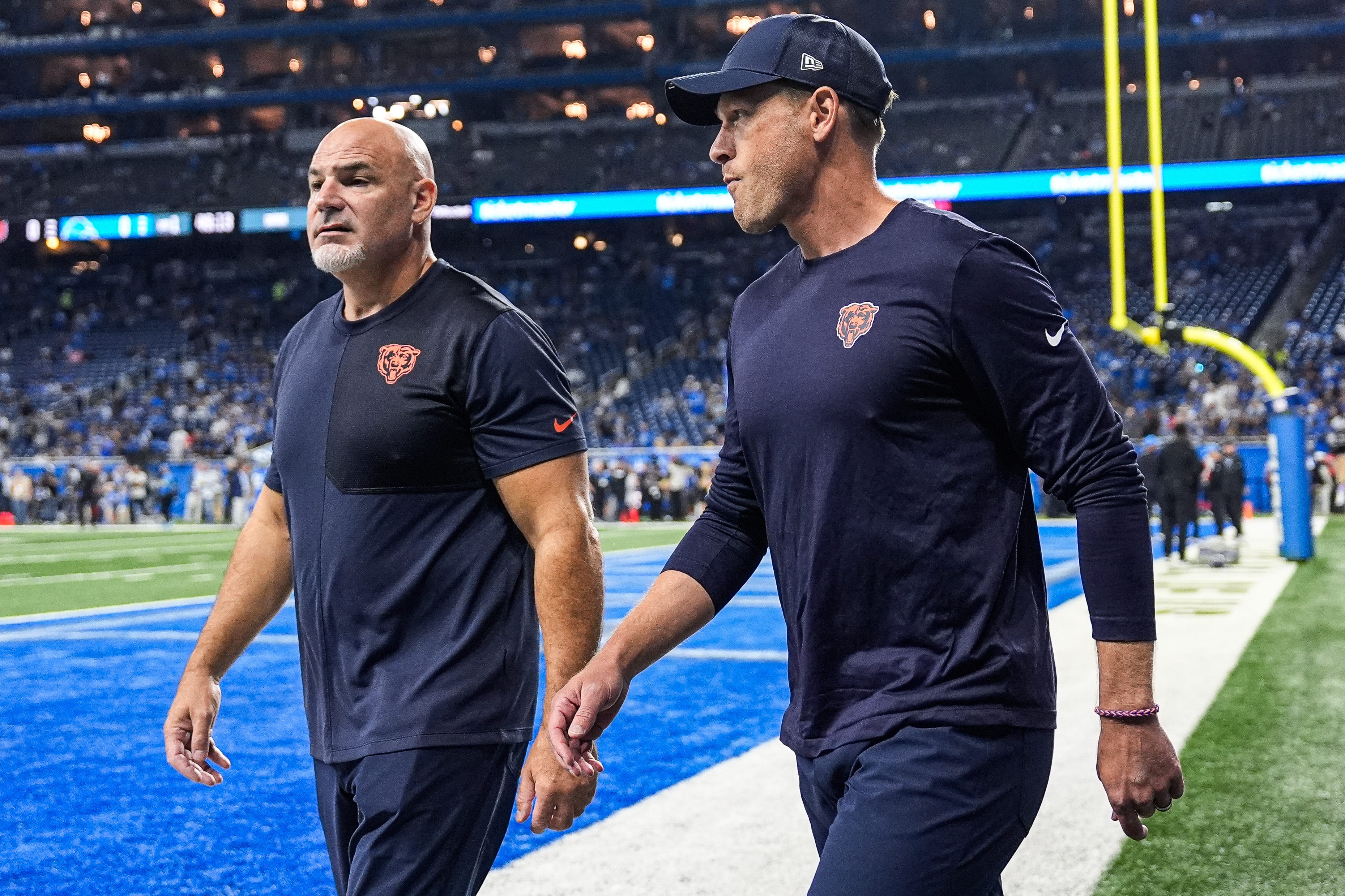 Chicago Bears head coach Ben Johnson walks onto the field to watch warm up at Ford Field in Detroit on Sunday, Sept. 14, 2025.