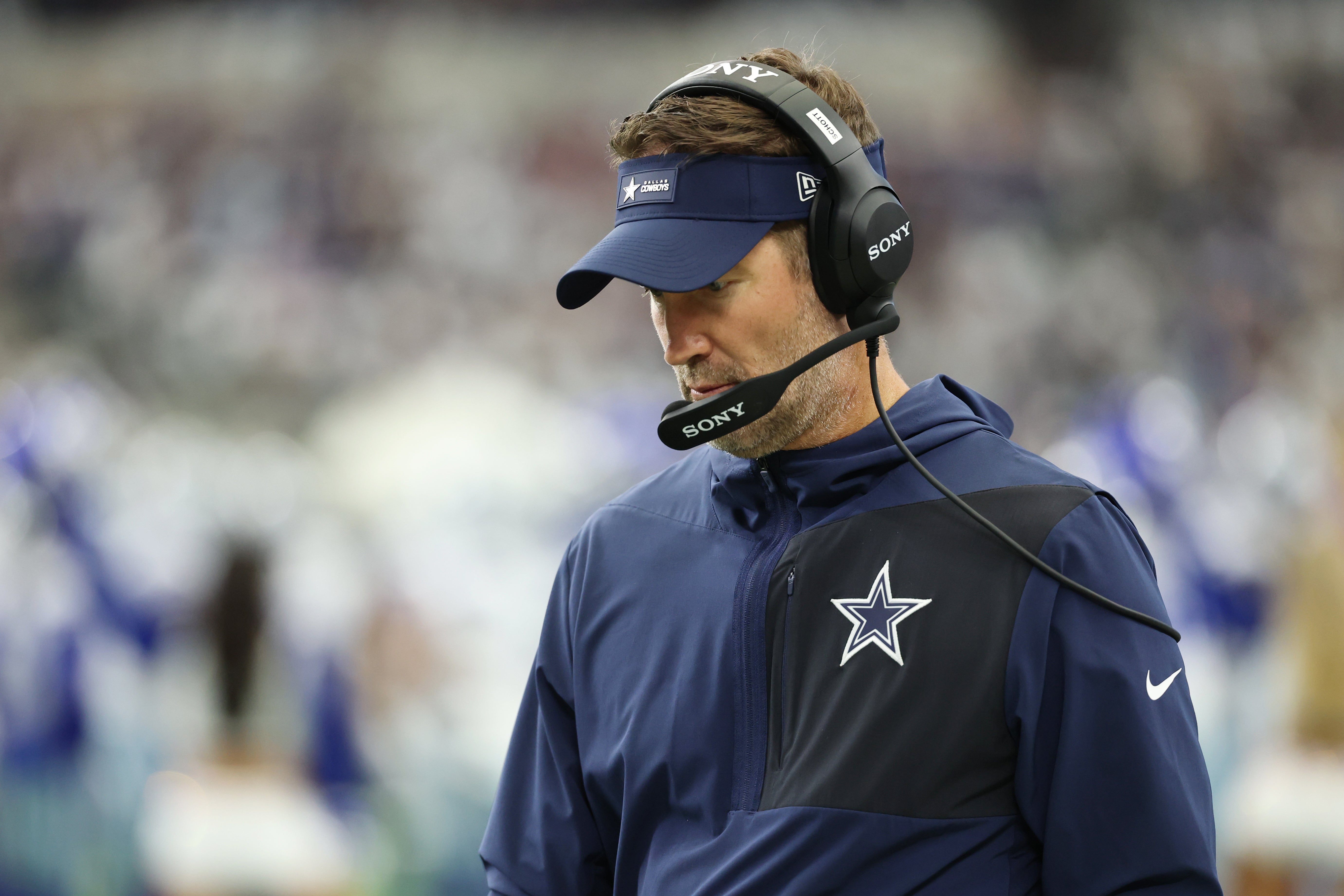 Sep 14, 2025; Arlington, Texas, USA; Dallas Cowboys head coach Brian Schottenheimer looks on from the sideline before the game against the New York Giants at AT&T Stadium.