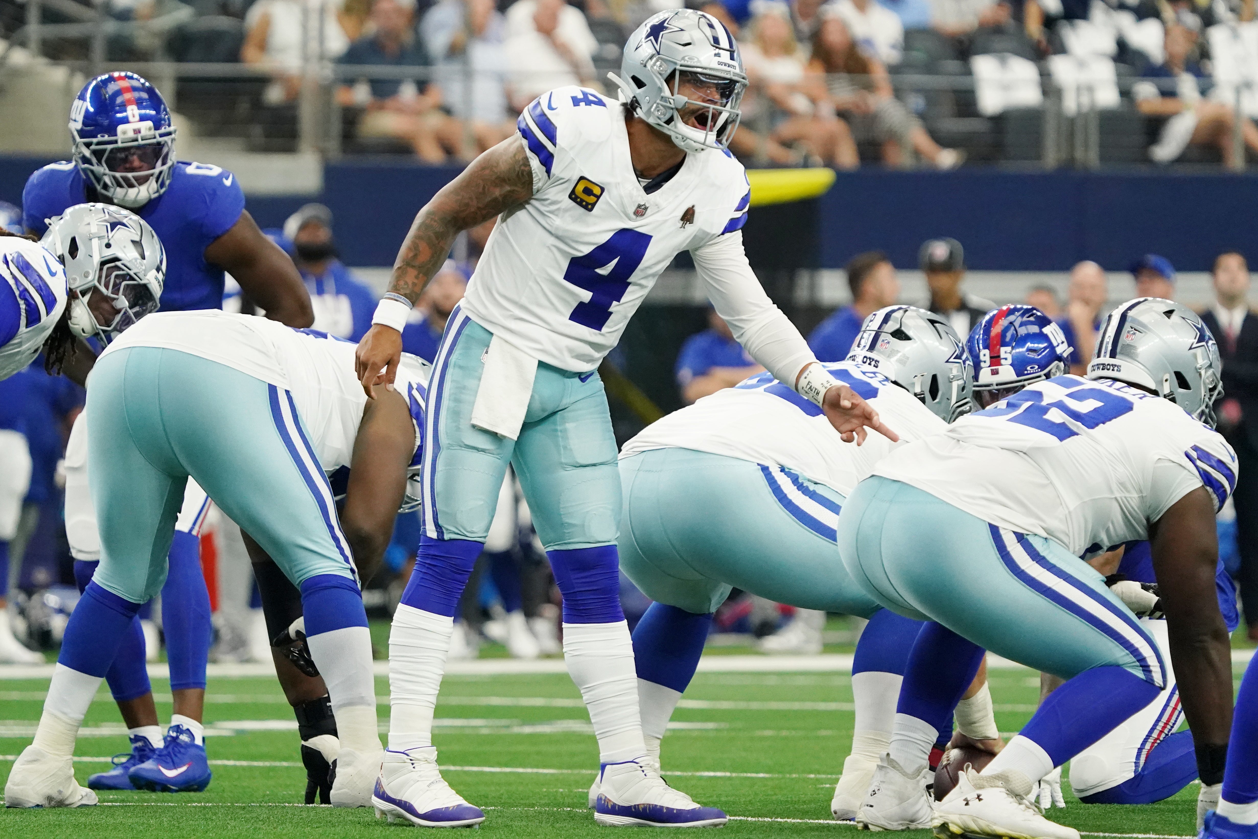 Sep 14, 2025; Arlington, Texas, USA; Dallas Cowboys quarterback Dak Prescott (4) signals to teammates before a snap against the New York Giants during the first quarter at AT&T Stadium.