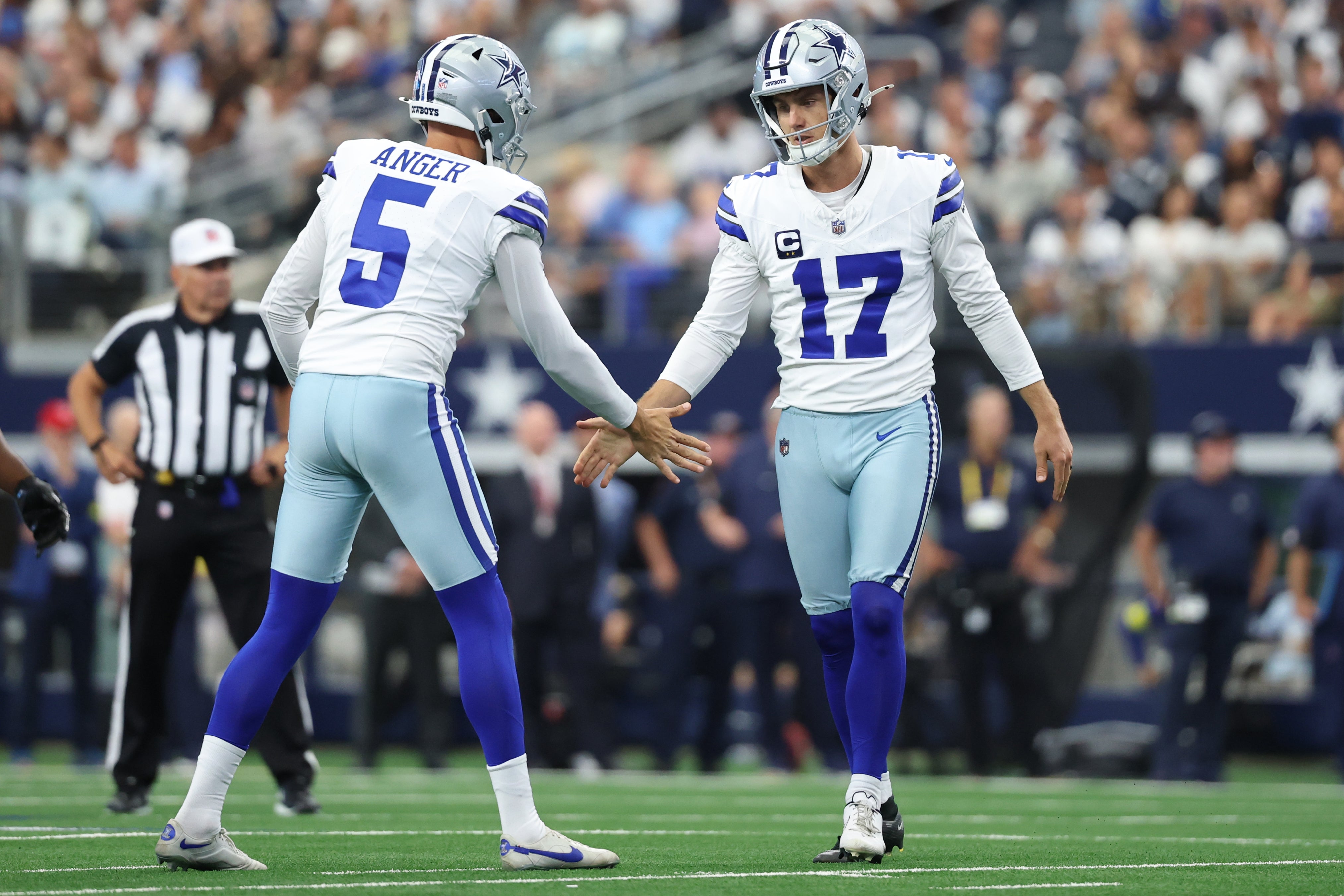 Dallas Cowboys place kicker Brandon Aubrey (17) high fives punter Bryan Anger (5) after a field goal against the New York Giants during the second quarter at AT&T Stadium.