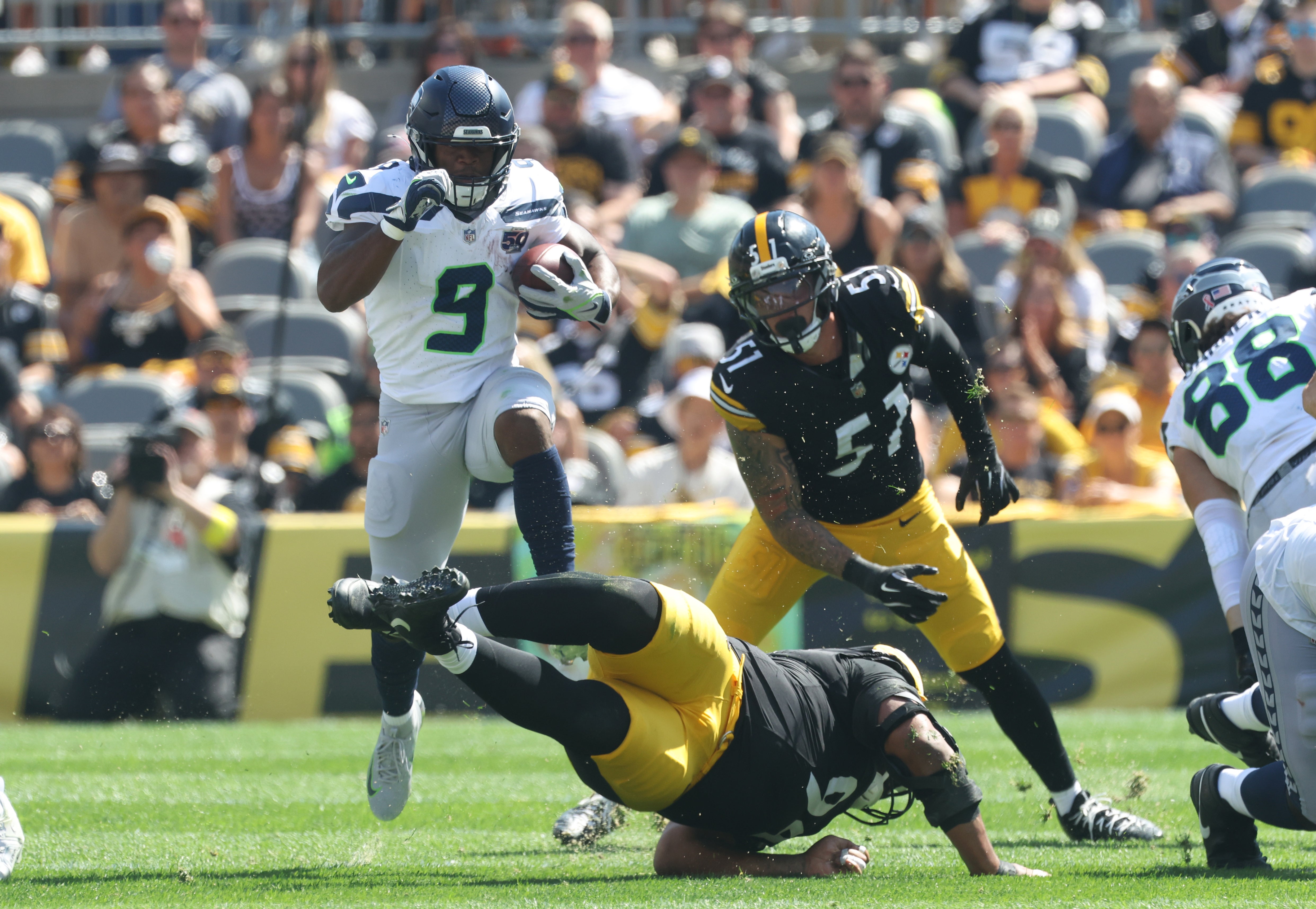Sep 14, 2025; Pittsburgh, Pennsylvania, USA; Seattle Seahawks running back Kenneth Walker III (9) leaps over Pittsburgh Steelers defensive tackle Yaha Black (bottom) on a second quarter carry at Acrisure Stadium.