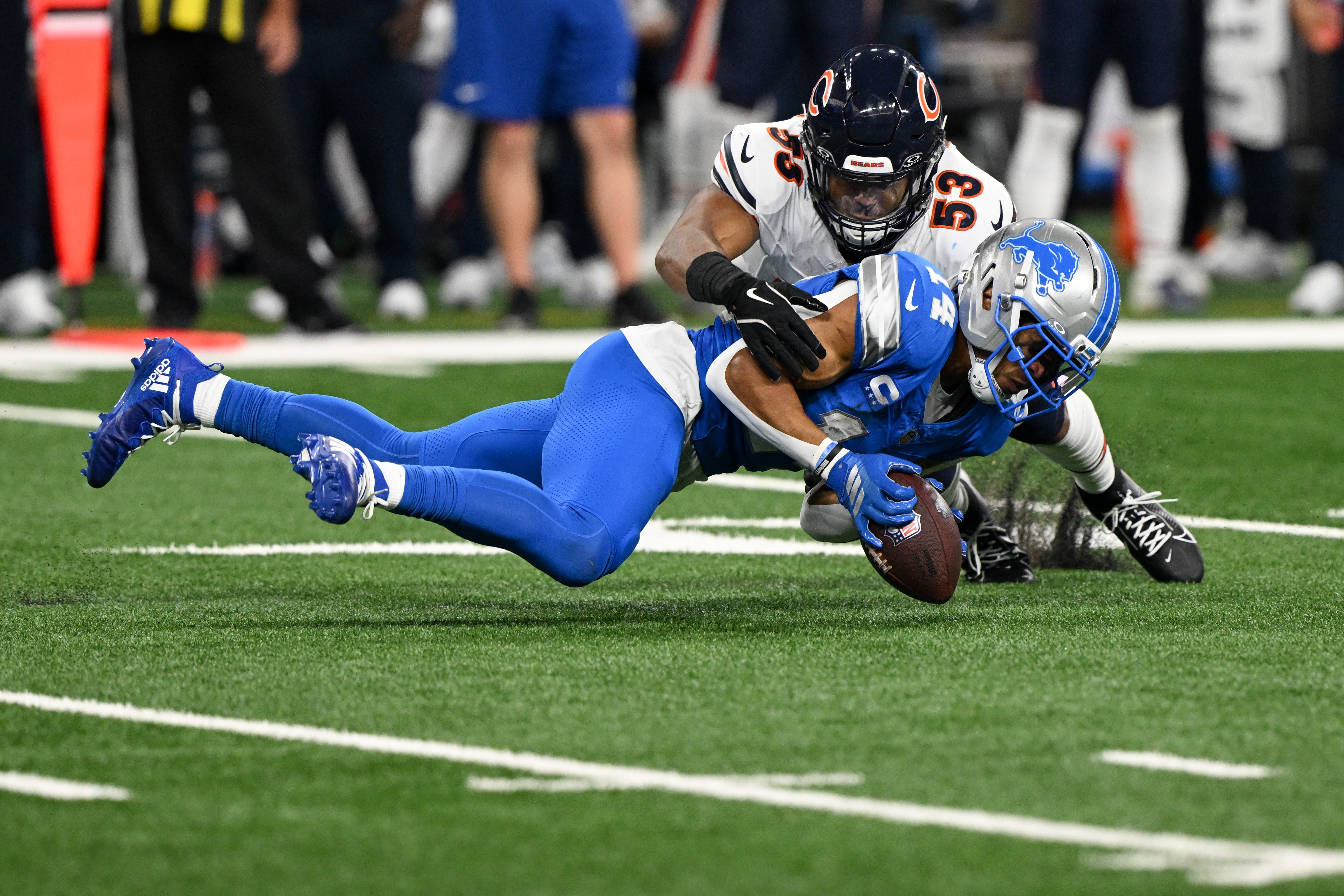 Sep 14, 2025; Detroit, Michigan, USA; Detroit Lions wide receiver Amon-Ra St. Brown (14) is unable to make a catch defended by Chicago Bears linebacker T.J. Edwards (53) during the second quarter of the game at Ford Field.