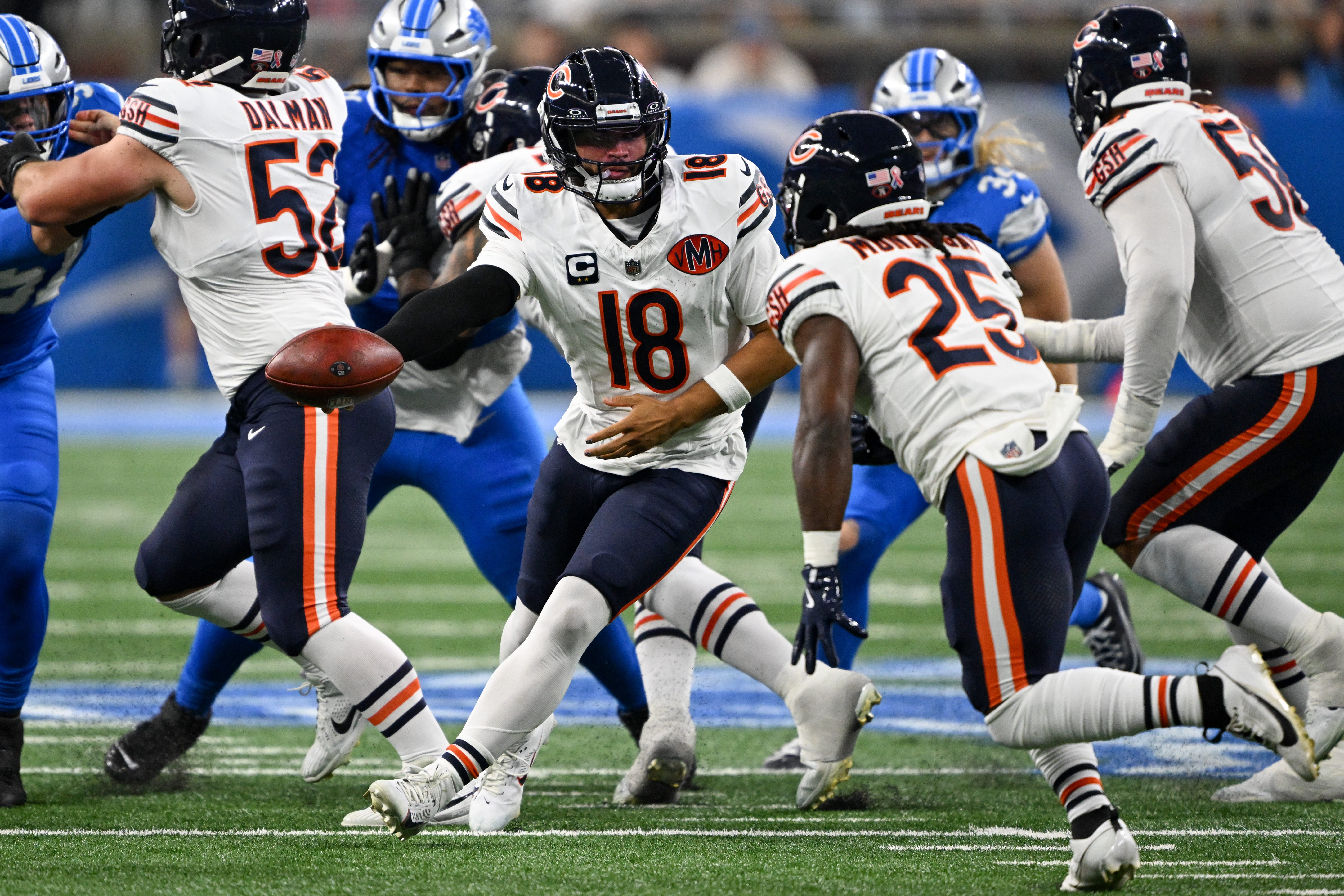 Sep 14, 2025; Detroit, Michigan, USA; Chicago Bears quarterback Caleb Williams (18) looks to hand off the ball to Chicago Bears running back Kyle Monangai (25) during the second quarter of the game at Ford Field.