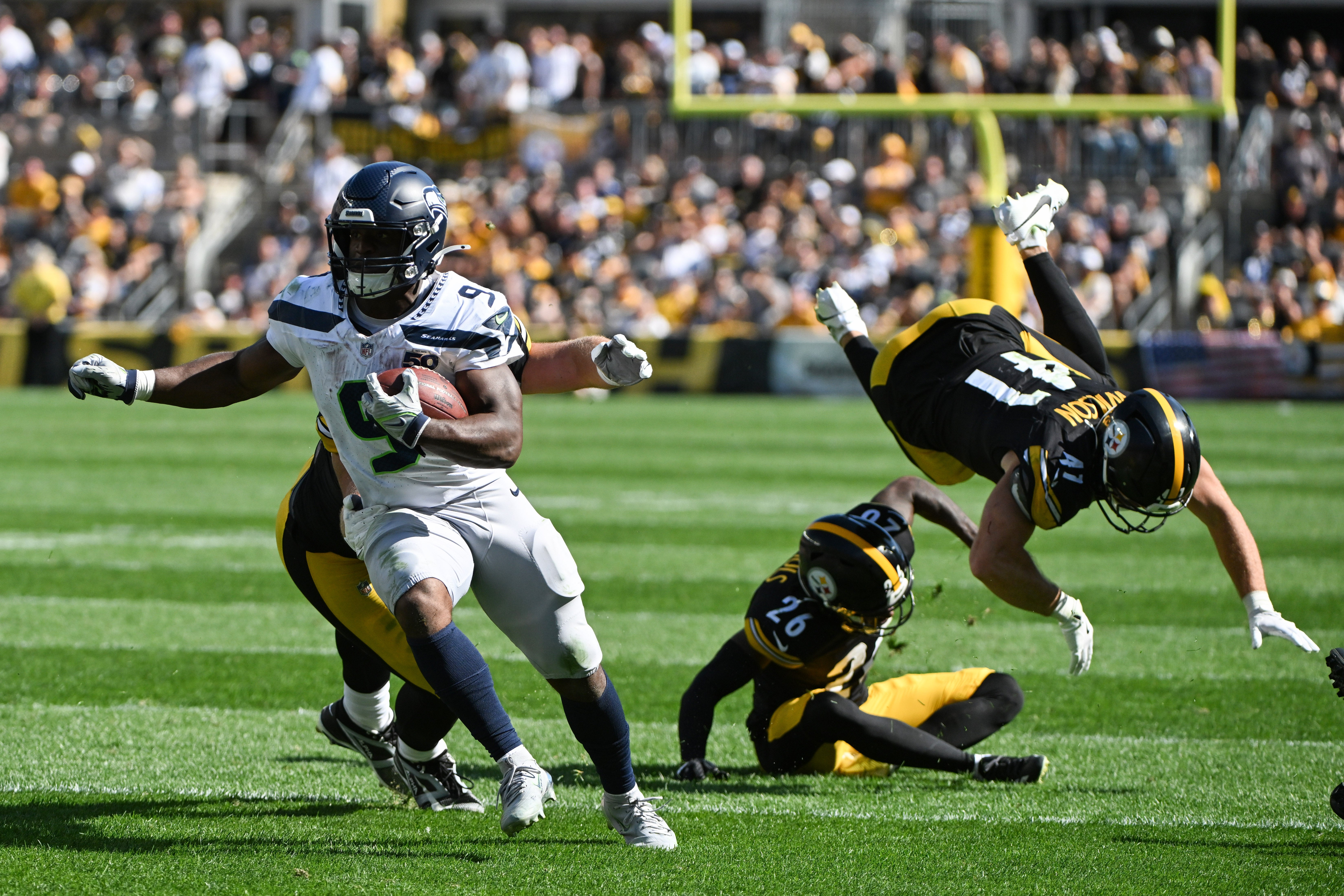 Sep 14, 2025; Pittsburgh, Pennsylvania, USA; Seattle Seahawks running back Kenneth Walker III (9) scores a touchdown in front of Pittsburgh Steelers defenders Brandin Echols (26) and Payton Wilson (41) during the second half at Acrisure Stadium