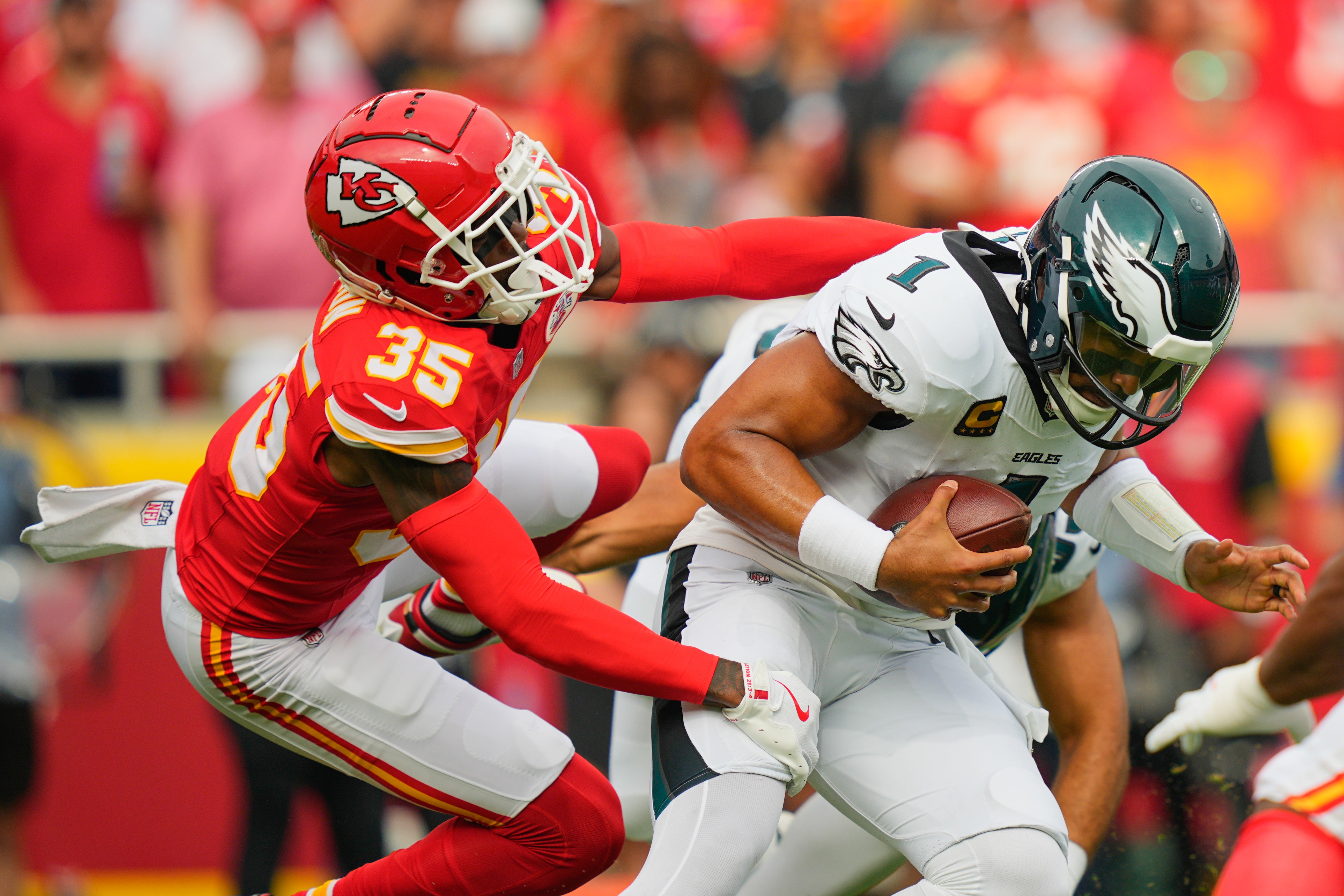Kansas City Chiefs cornerback Jaylen Watson (35) sacks Philadelphia Eagles quarterback Jalen Hurts (1) during the first quarter of the game at GEHA Field at Arrowhead Stadium.
