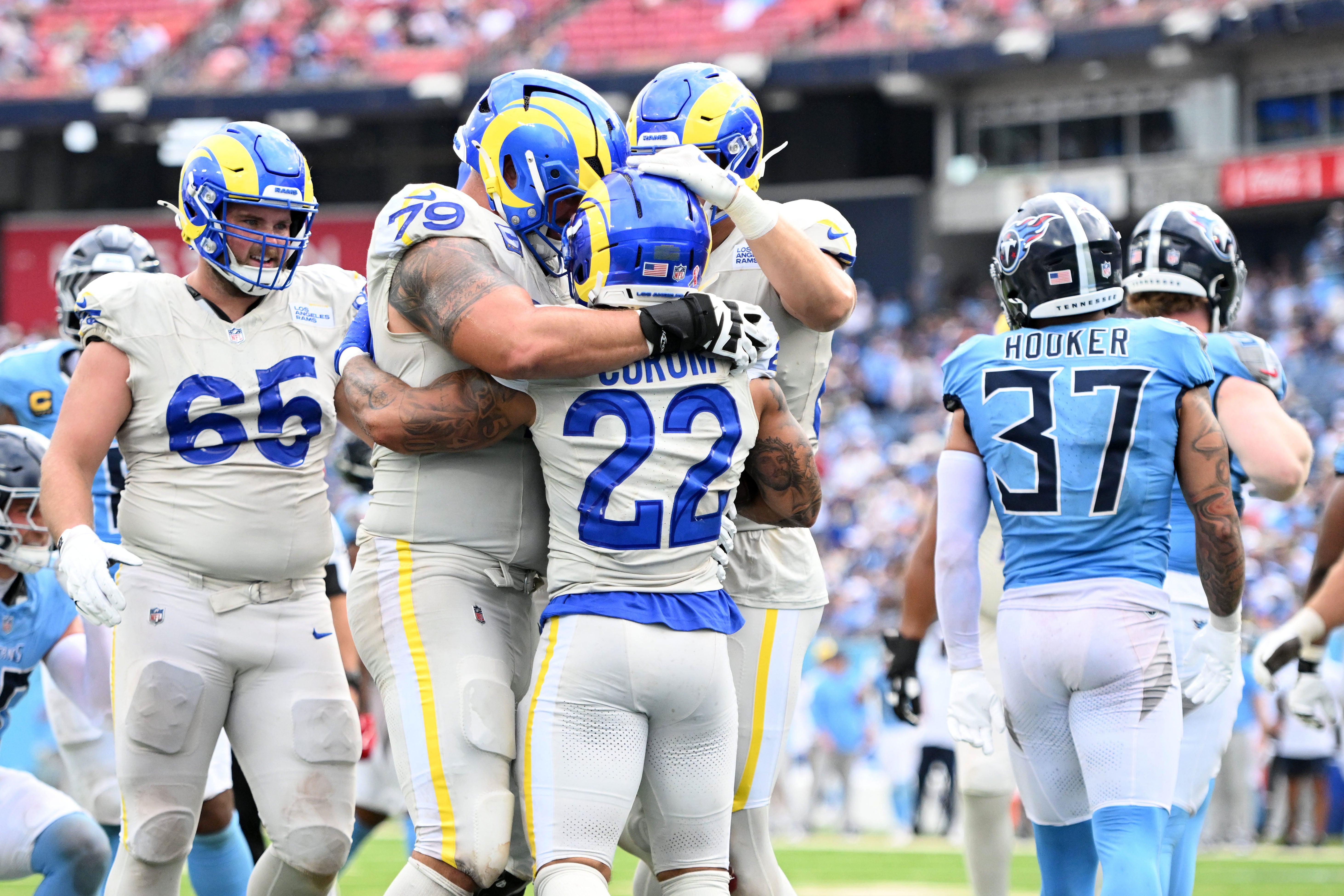 Sep 14, 2025; Nashville, Tennessee, USA; Los Angeles Rams running back Blake Corum (22) reacts after scoring a touchdown against the Tennessee Titans during the second half at Nissan Stadium.