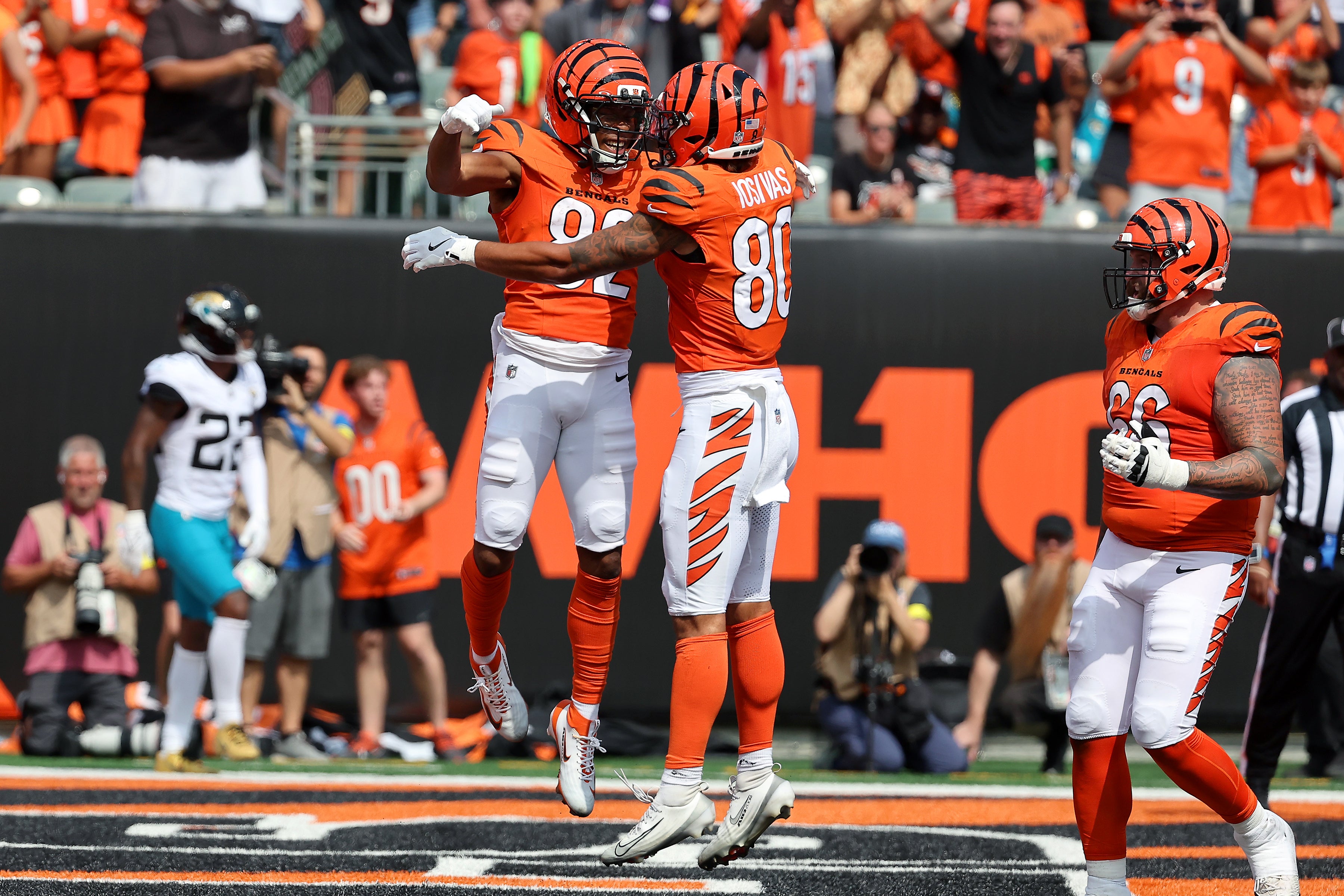 Sep 14, 2025; Cincinnati, Ohio, USA; Cincinnati Bengals wide receiver Mitchell Tinsley (left) celebrates his touchdown catch with wide receiver Andrei Iosivas (80) during the third quarter against the Jacksonville Jaguars at Paycor Stadium.