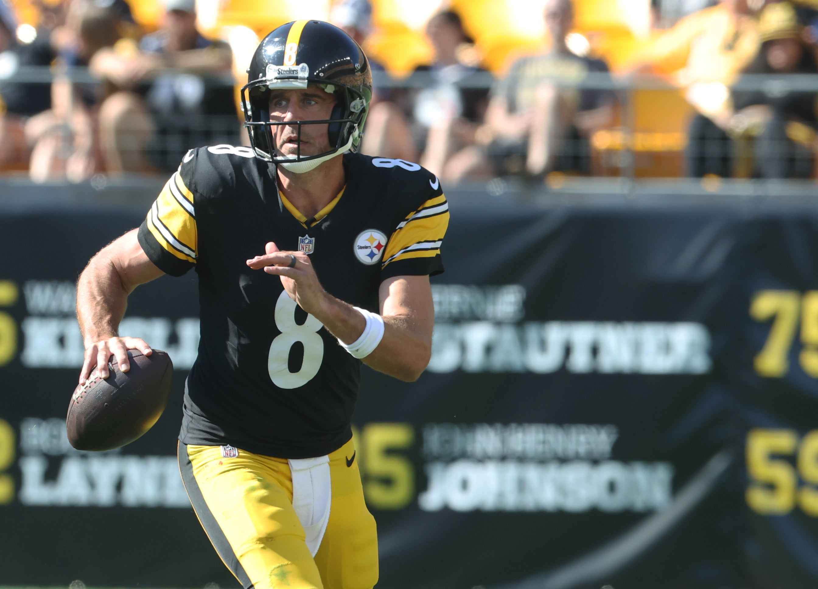 Sep 14, 2025; Pittsburgh, Pennsylvania, USA; Pittsburgh Steelers quarterback Aaron Rodgers (8) scrambles with the ball against the Seattle Seahawks during the fourth quarter at Acrisure Stadium.