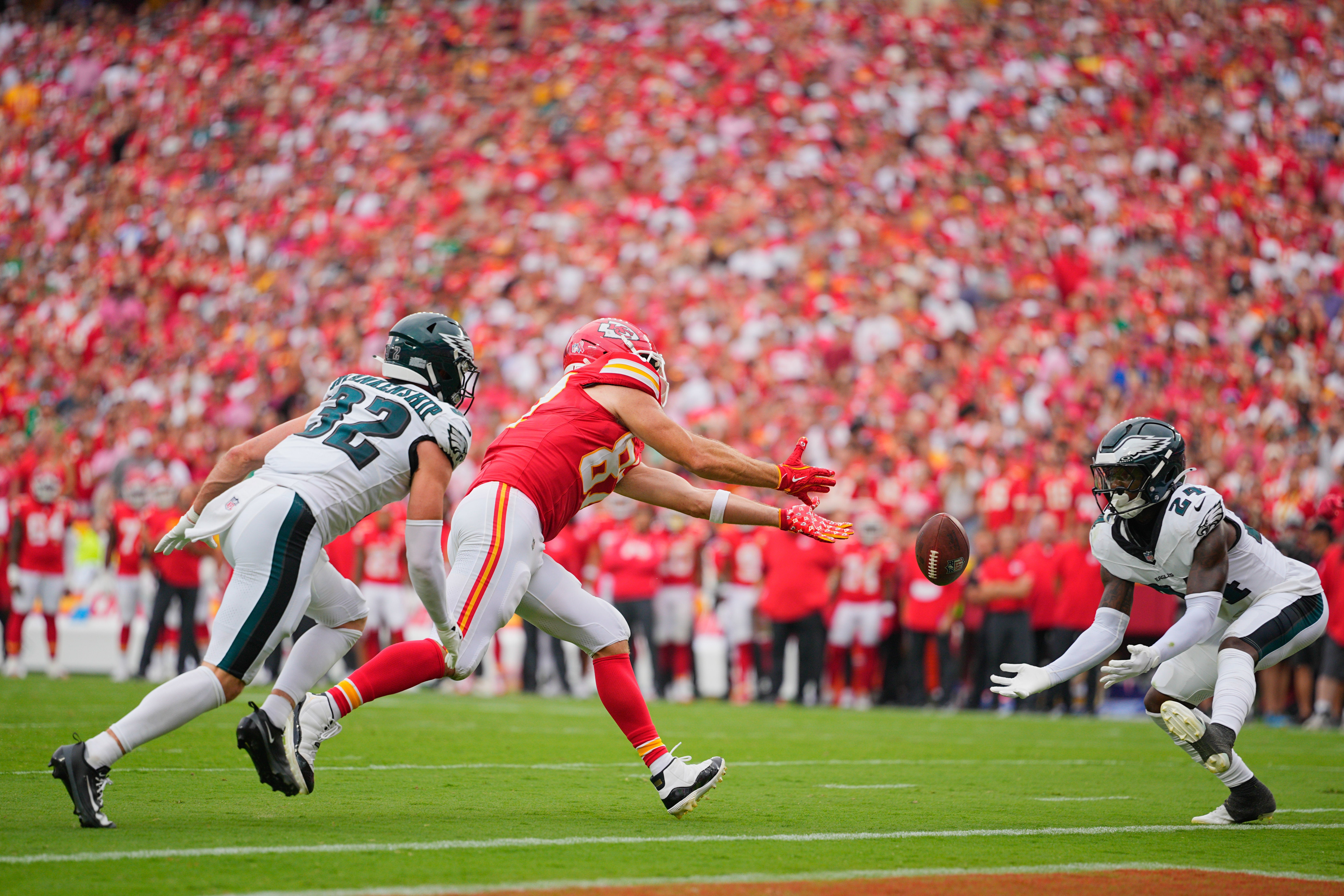 Philadelphia Eagles safety Andrew Mukuba (24) intercepts a pass intended for Kansas City Chiefs tight end Travis Kelce (87) during the fourth quarter of the game at GEHA Field at Arrowhead Stadium.