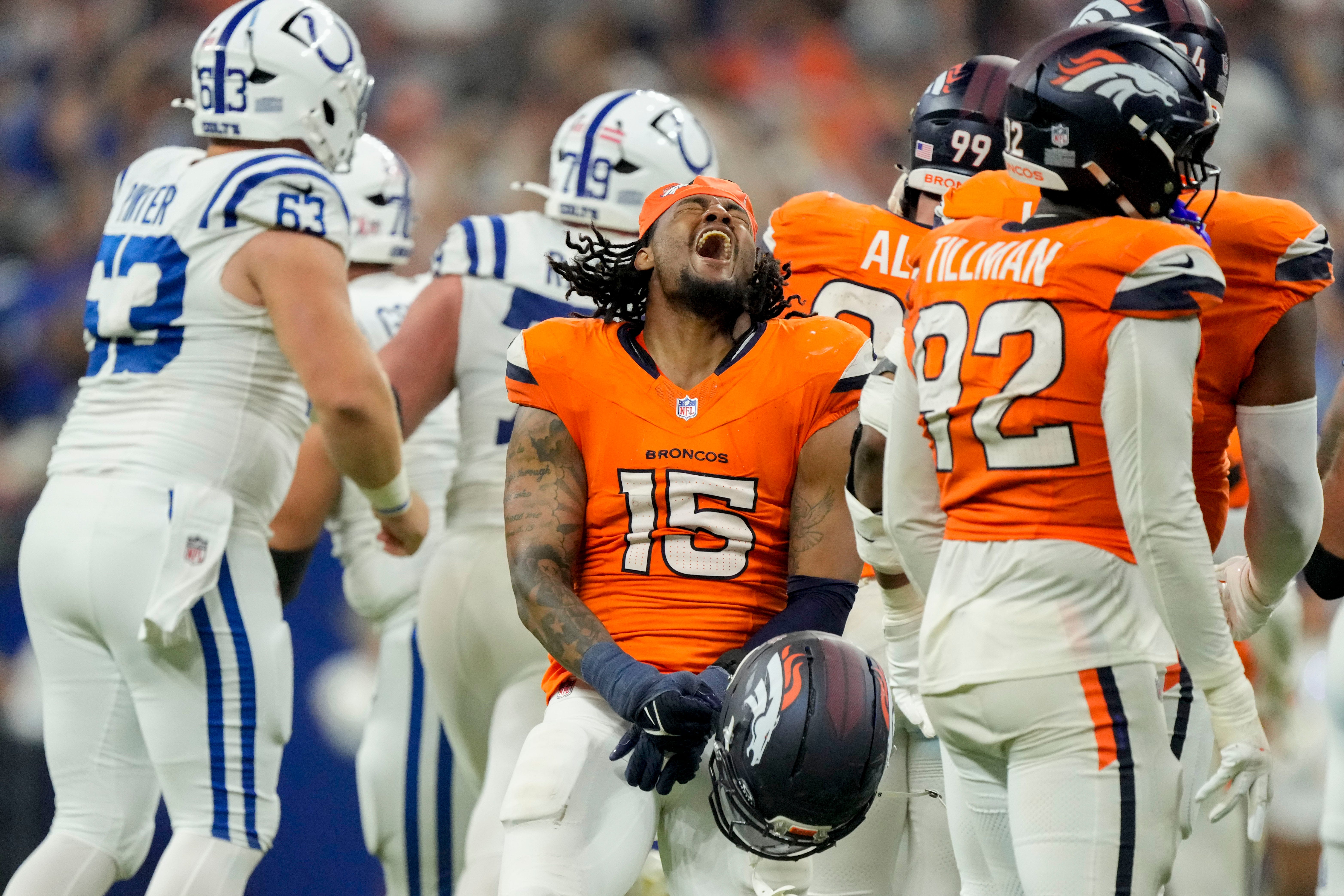 Denver Broncos linebacker Nik Bonitto (15) reacts after a missed field goal by Indianapolis Colts place kicker Spencer Shrader (3) on Sunday, Sept. 14, 2025, during a game at Lucas Oil Stadium in Indianapolis. A penalty on the Broncos game Shrader a second attempt which he made to win the game.