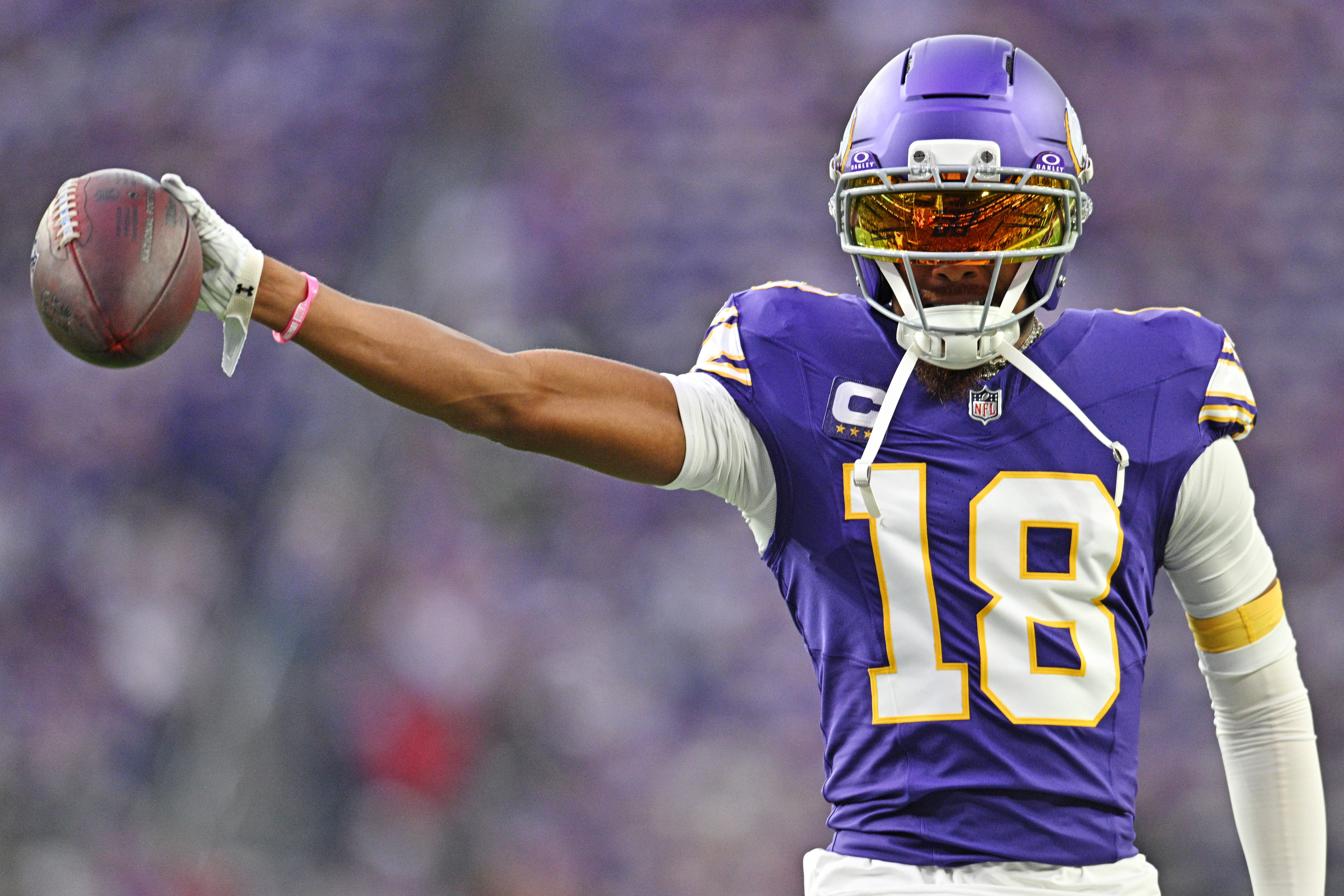 Sep 14, 2025; Minneapolis, Minnesota, USA; Minnesota Vikings wide receiver Justin Jefferson (18) holds out the ball before the game against the Atlanta Falcons at U.S. Bank Stadium.