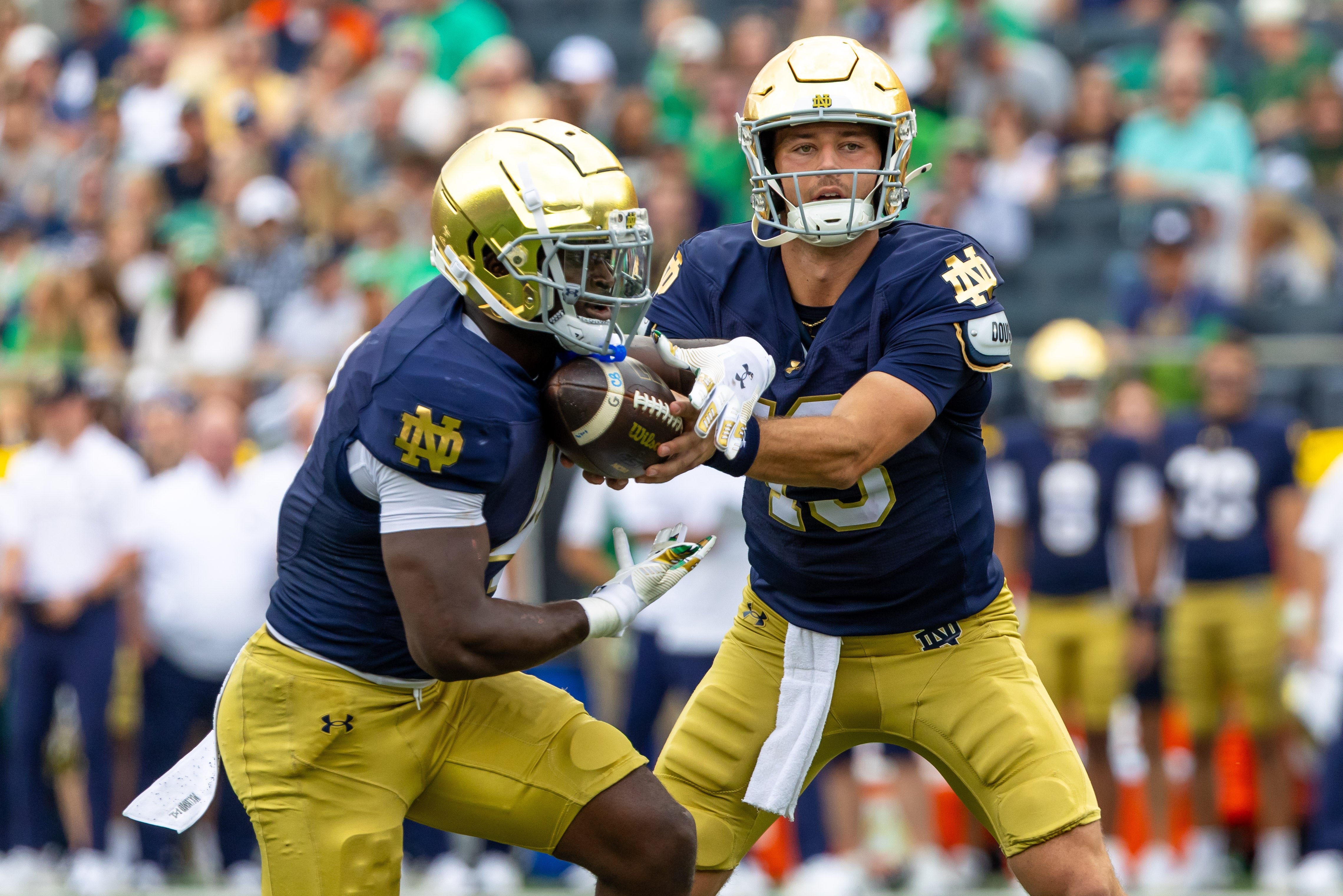 Sep 20, 2025; South Bend, Indiana, USA; Notre Dame Fighting Irish quarterback CJ Carr (13) hands off to Notre Dame Fighting Irish running back Jeremiyah Love (4) against the Purdue Boilermakers during the first half at Notre Dame Stadium. Mandatory Credit: Michael Caterina-Imagn Images