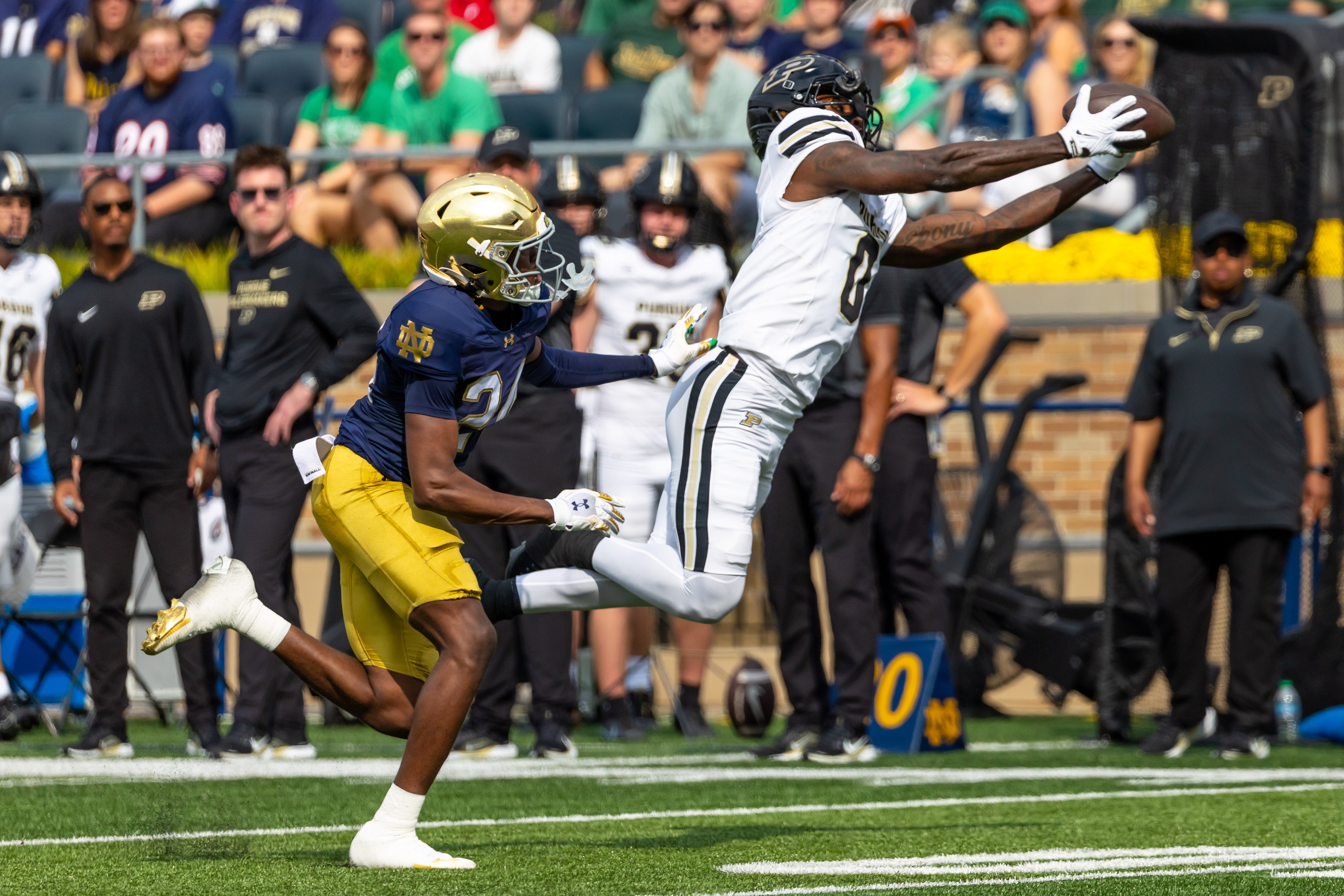 Sep 20, 2025; South Bend, Indiana, USA; Purdue Boilermakers wide receiver Nitro Tuggle (0) makes a catch as Notre Dame Fighting Irish cornerback Mark Zackery IV (24) defends during the first half at Notre Dame Stadium. Mandatory Credit: Michael Caterina-Imagn Images