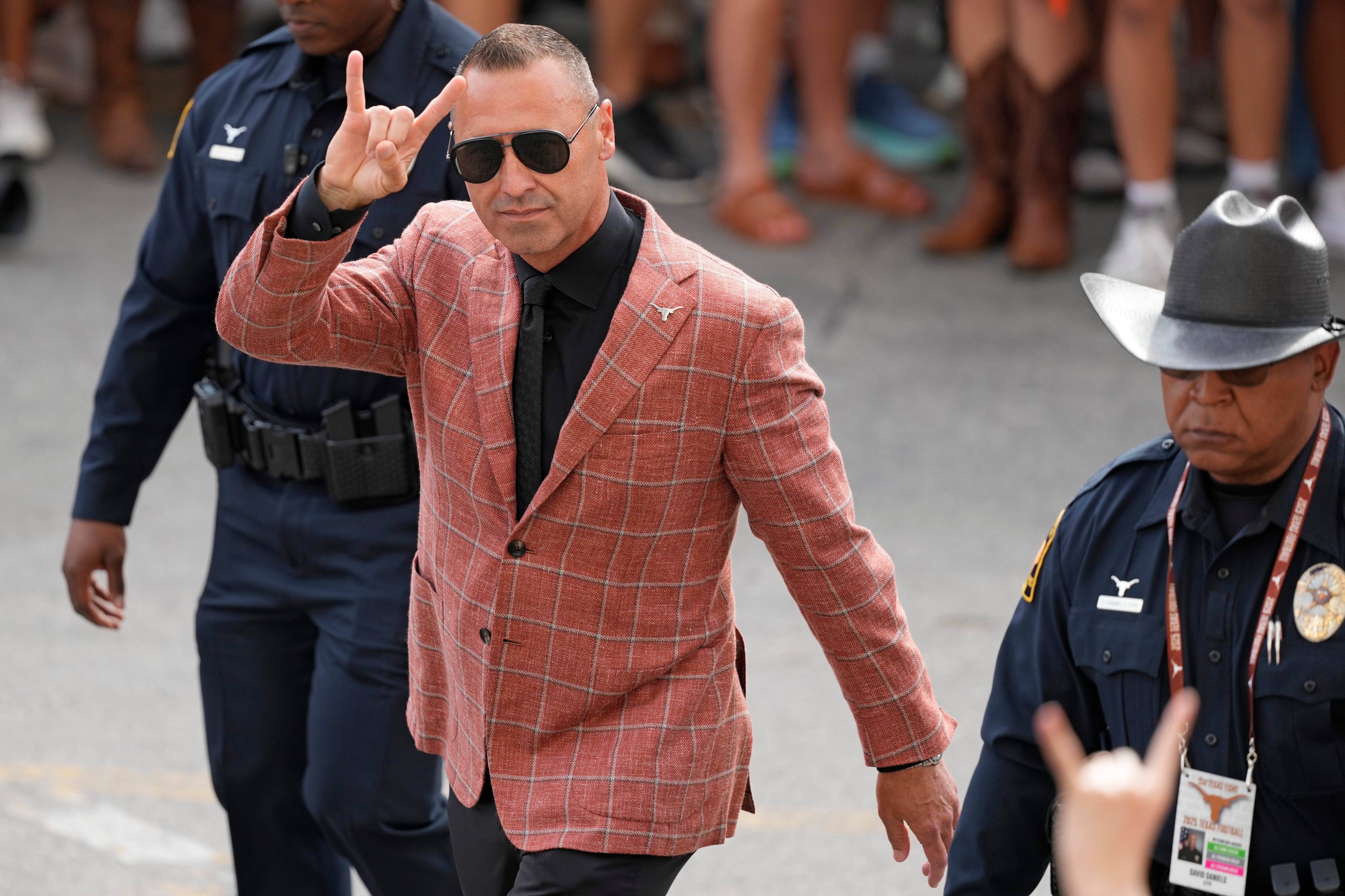 Sep 20, 2025; Austin, Texas, USA; Texas Longhorns head coach Steve Sarkisian holds up his horns while entering Darrell K Royal-Texas Memorial Stadium before a game against the Sam Houston State Bearkats.