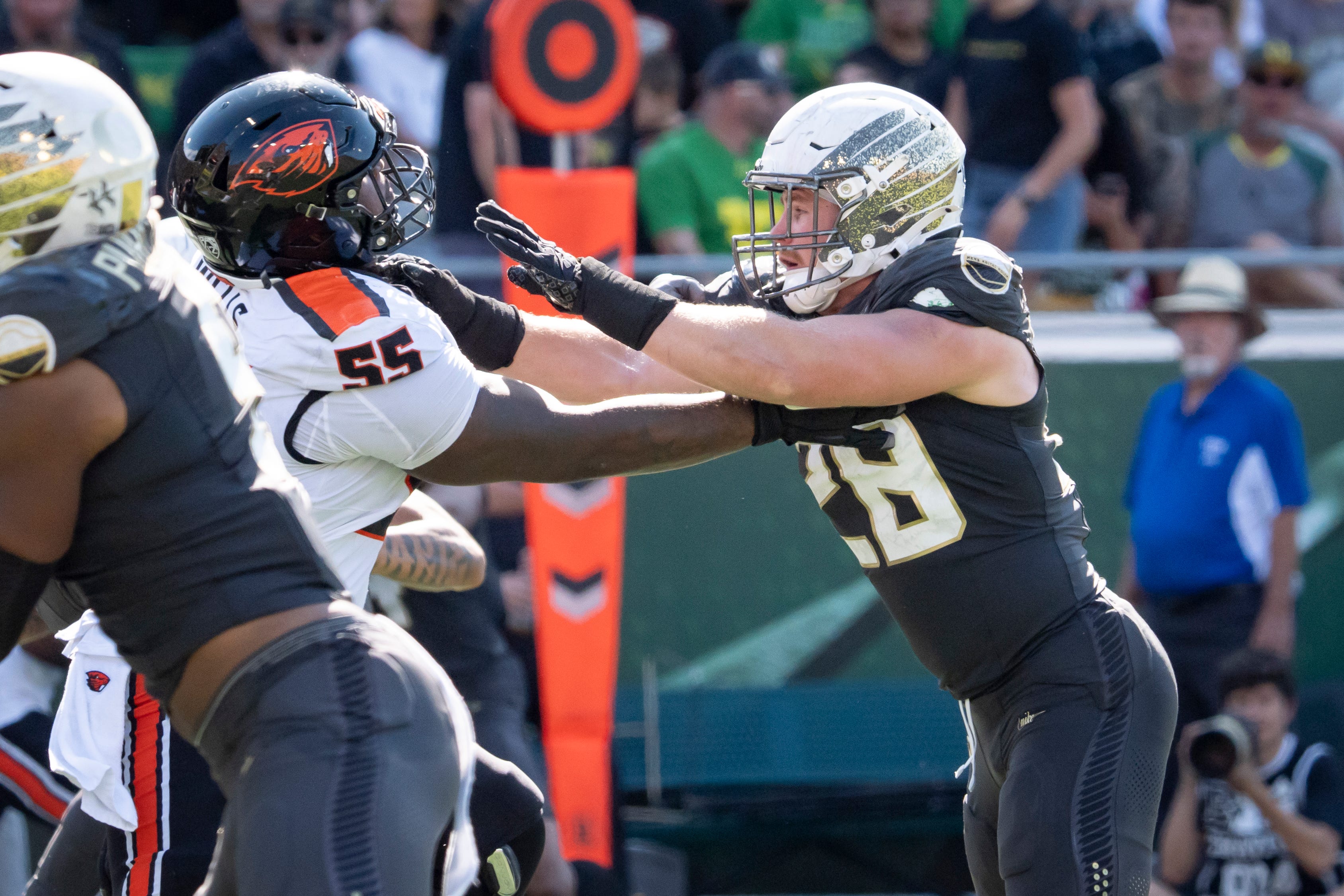 Oregon Ducks inside linebacker Bryce Boettcher, right, blocks Oregon State Beavers offensive lineman Van Wells as the Oregon Ducks host the Oregon State Beavers Sept. 20, 2025, at Autzen Stadium in Eugene, Oregon.
