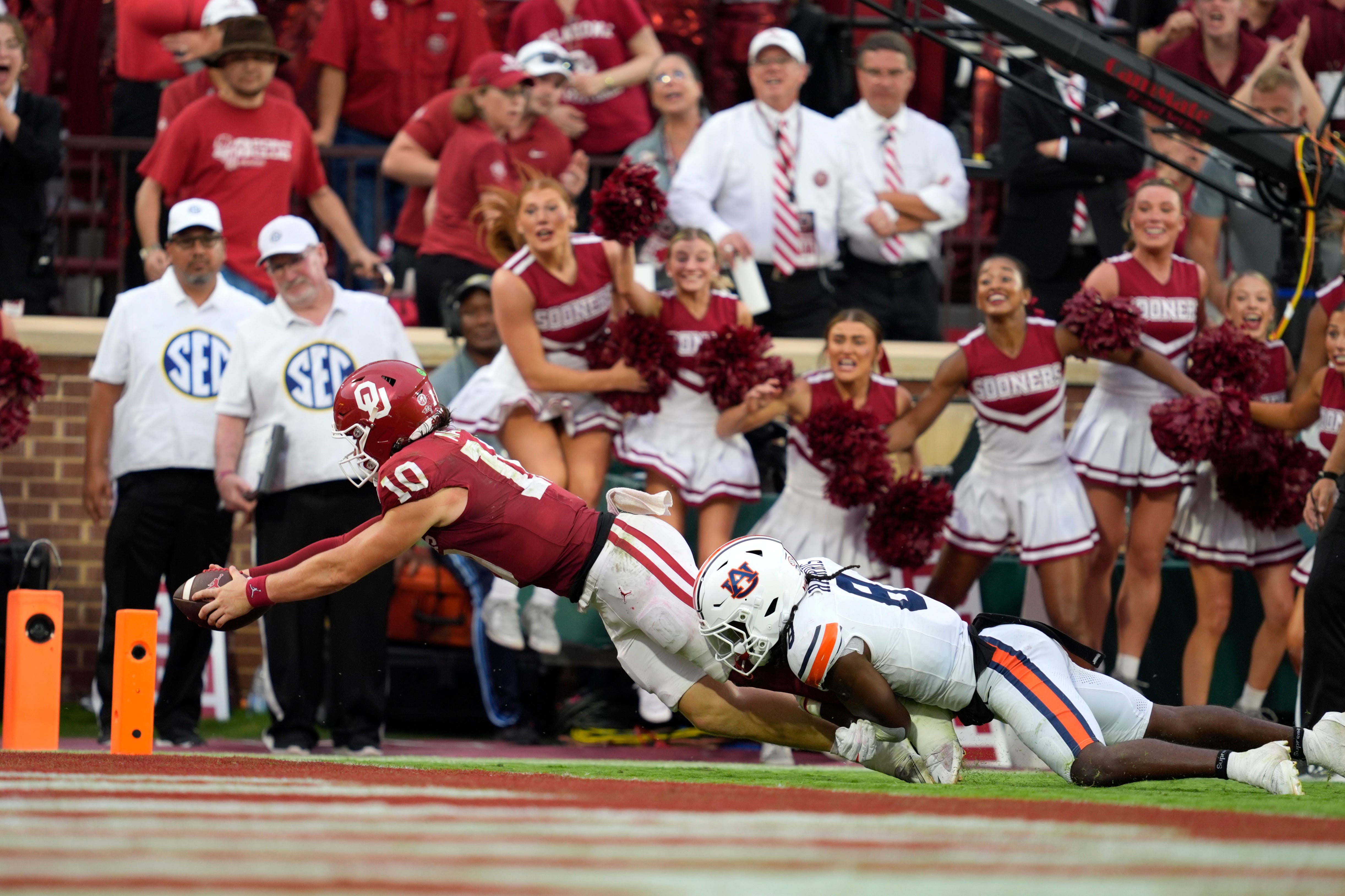 Oklahoma Sooners quarterback John Mateer (10) dives past Auburn Tigers safety Kaleb Harris (8) to score a touchdown during a college football game between the University of Oklahoma Sooners (OU) and the Auburn Tigers at Gaylord Family Ð Oklahoma Memorial Stadium in Norman, Okla., Saturday,Sept. 20, 2025. Oklahoma won 24-17.