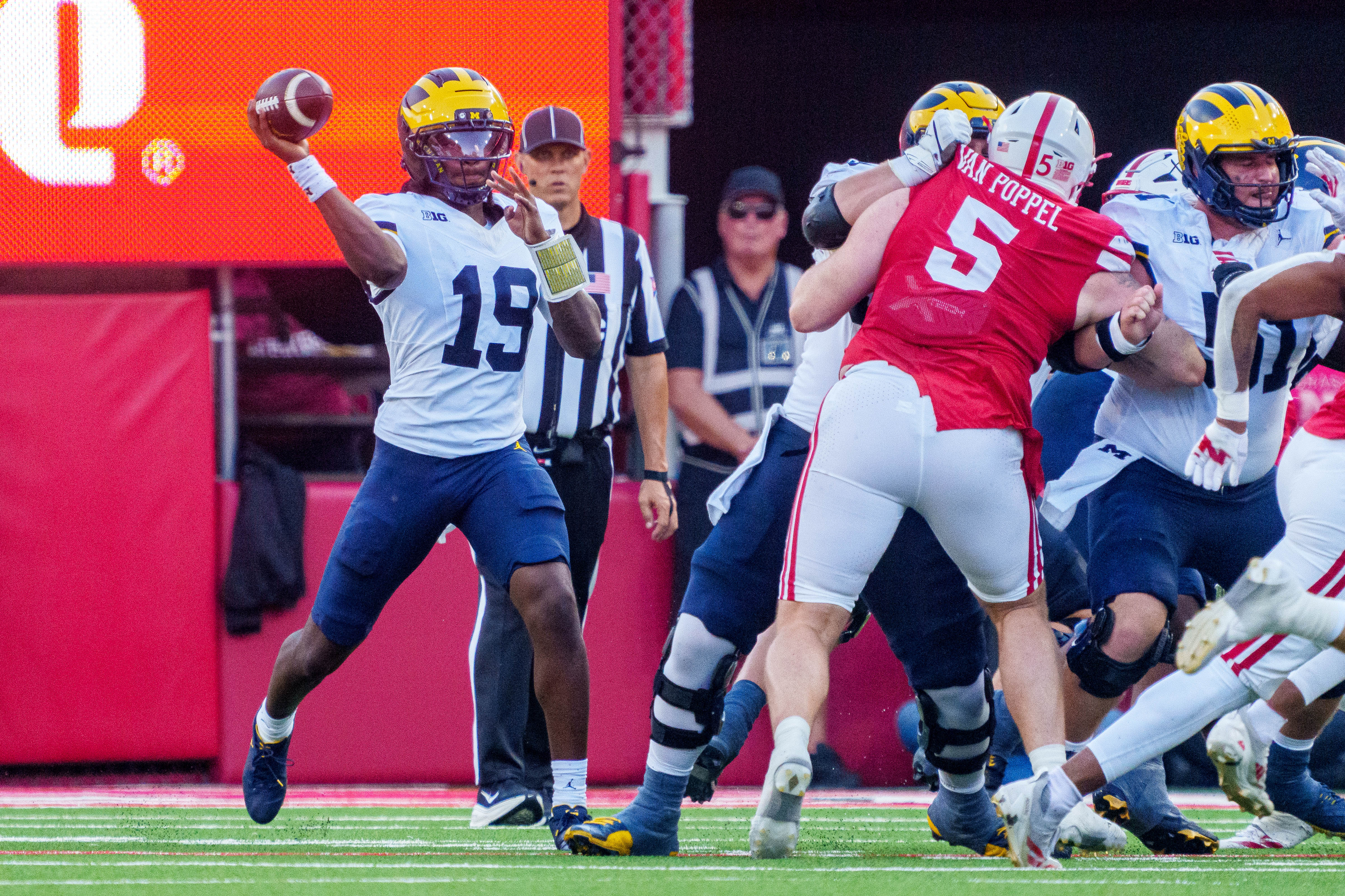 Sep 20, 2025; Lincoln, Nebraska, USA; Michigan Wolverines quarterback Bryce Underwood (19) passes against Nebraska Cornhuskers defensive lineman Riley Van Poppel (5) during the fourth quarter at Memorial Stadium.