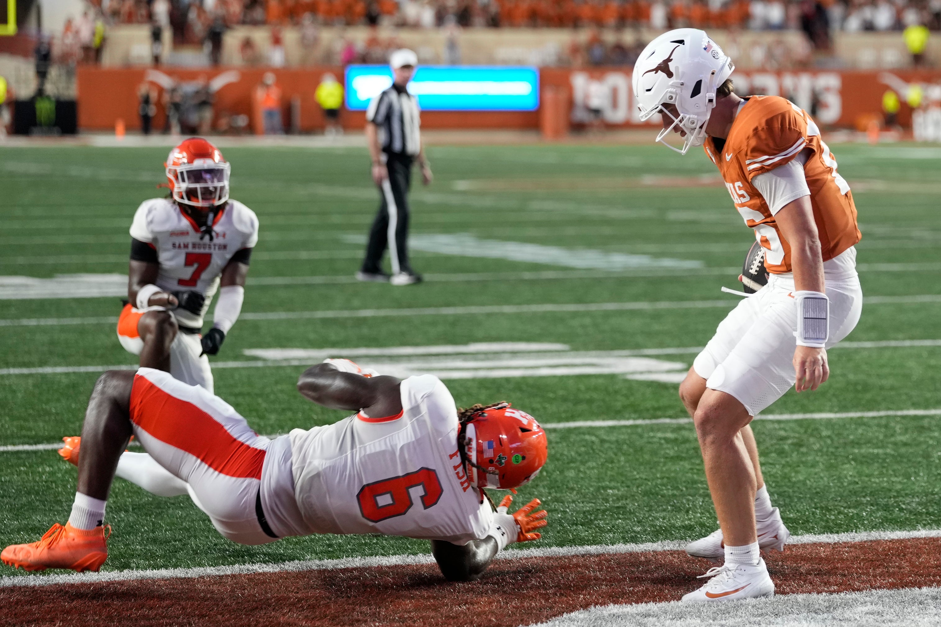 Sep 20, 2025; Austin, Texas, USA; Texas Longhorns quarterback Arch Manning (16) runs in for a touchdown past Sam Houston Bearkats linebacker Antivirus Fish (6) during the first half at Darrell K Royal-Texas Memorial Stadium.