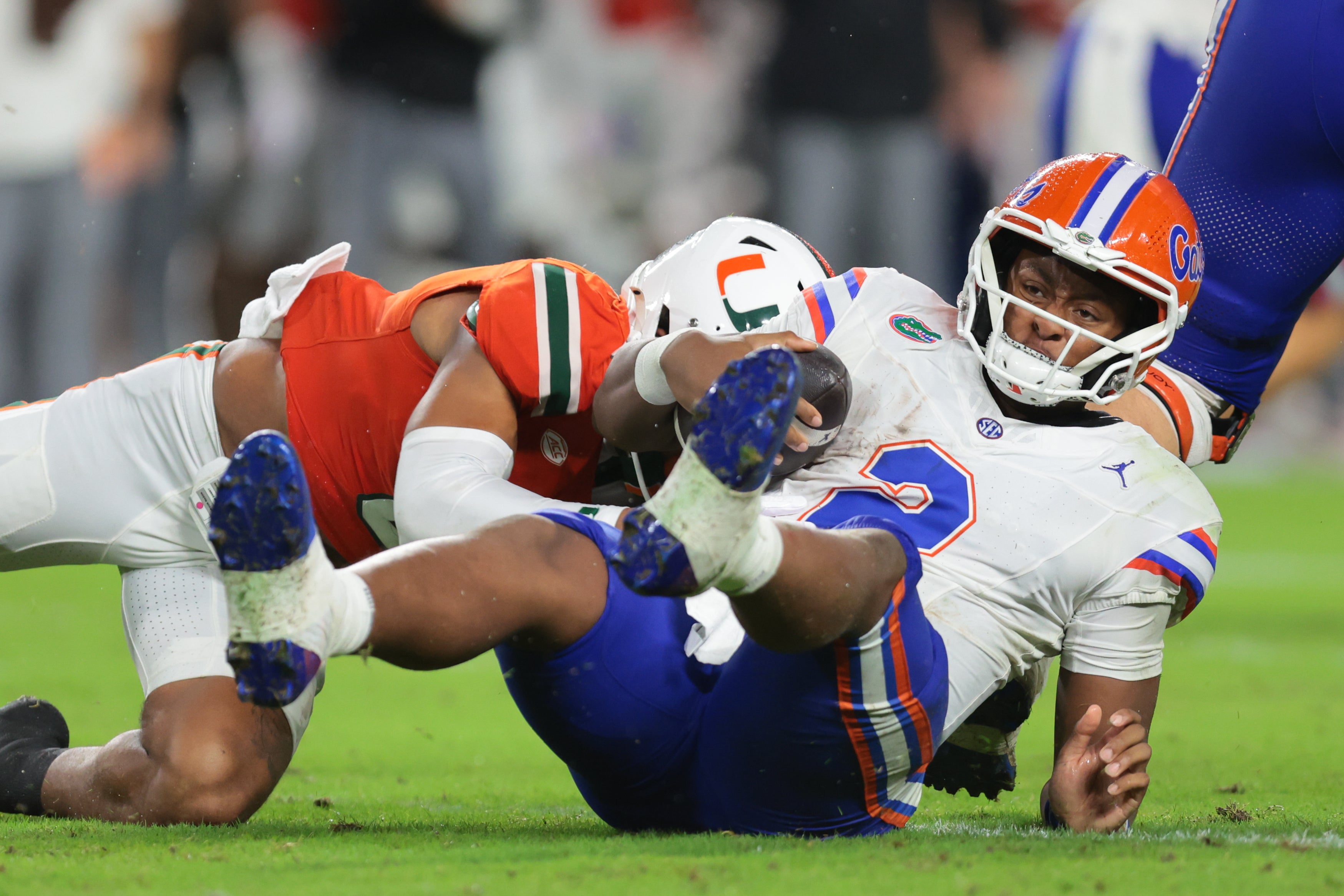 Sep 20, 2025; Miami Gardens, Florida, USA; Florida Gators quarterback DJ Lagway (2) is sacked by Florida Gators linebacker Aaron Chiles (8) during the second quarter at Hard Rock Stadium.