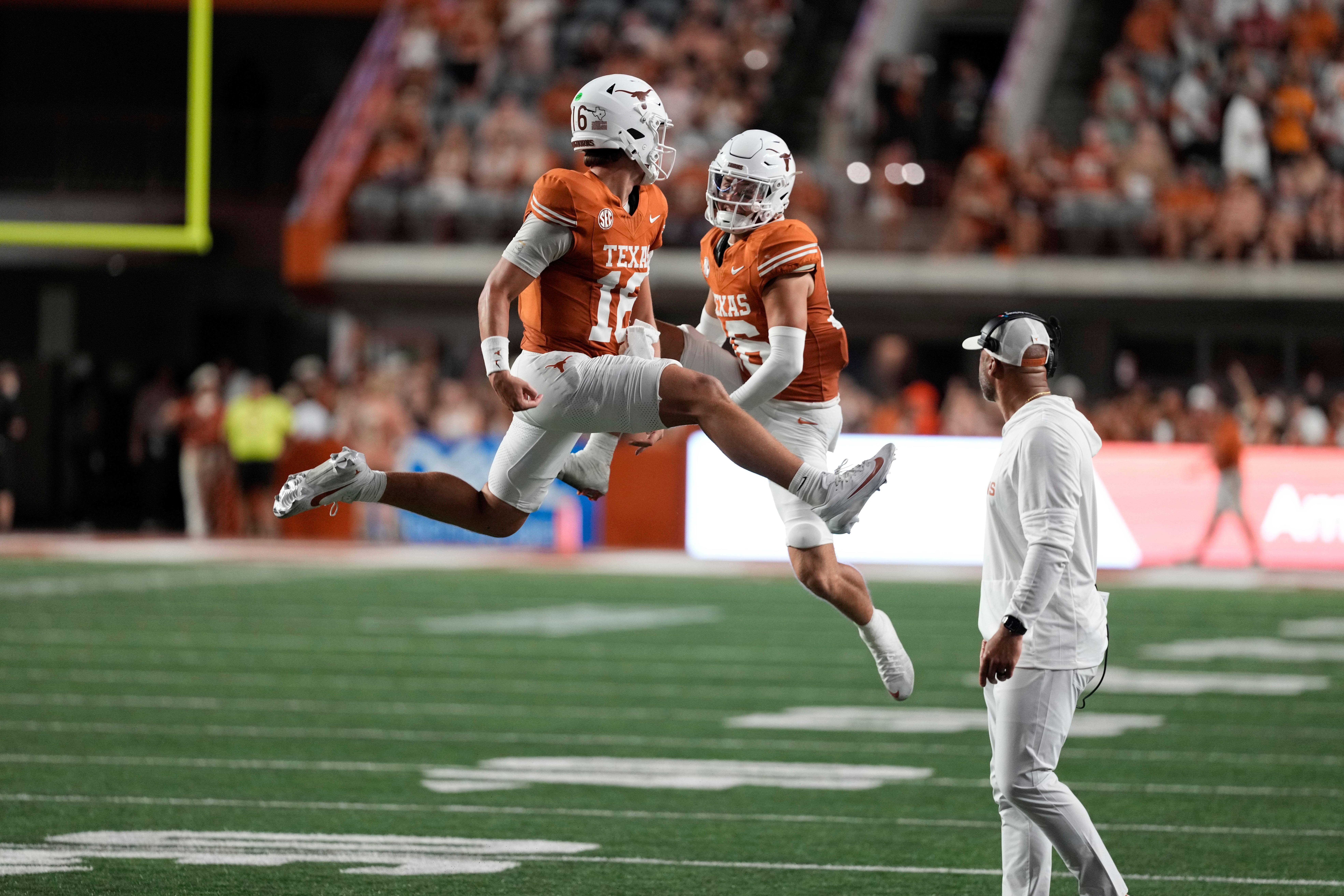 Sep 20, 2025; Austin, Texas, USA; Texas Longhorns quarterback Arch Manning (16) and defensive back Michael Taaffe (16) celebrate after Manning ran for a touchdown during the first half against the Sam Houston Bearkats at Darrell K Royal-Texas Memorial Stadium.