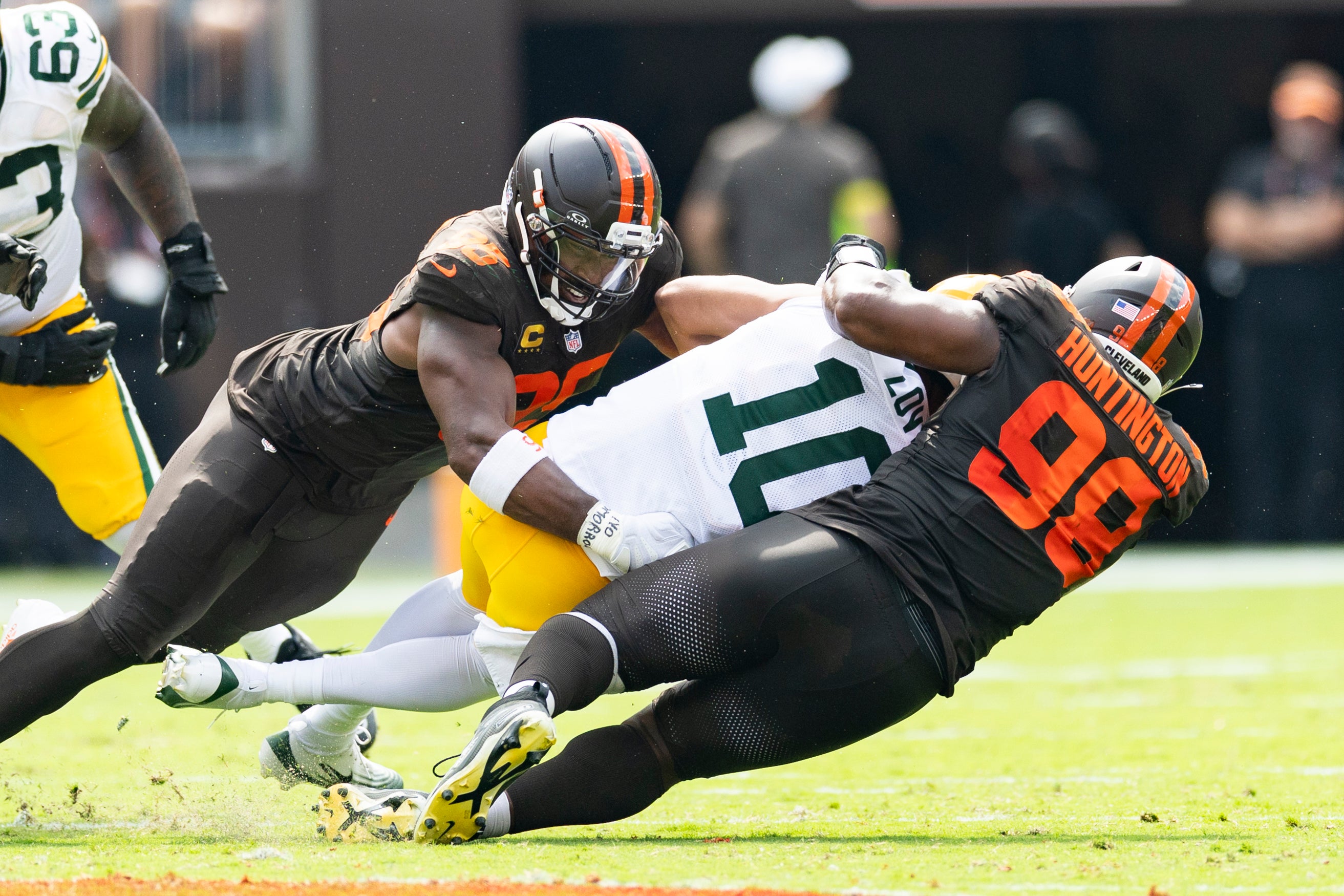 Sep 21, 2025; Cleveland, Ohio, USA; Cleveland Browns defensive end Myles Garrett (95) and defensive end Adin Huntington (98) sack Green Bay Packers quarterback Jordan Love (10) during the second quarter at Huntington Bank Field.