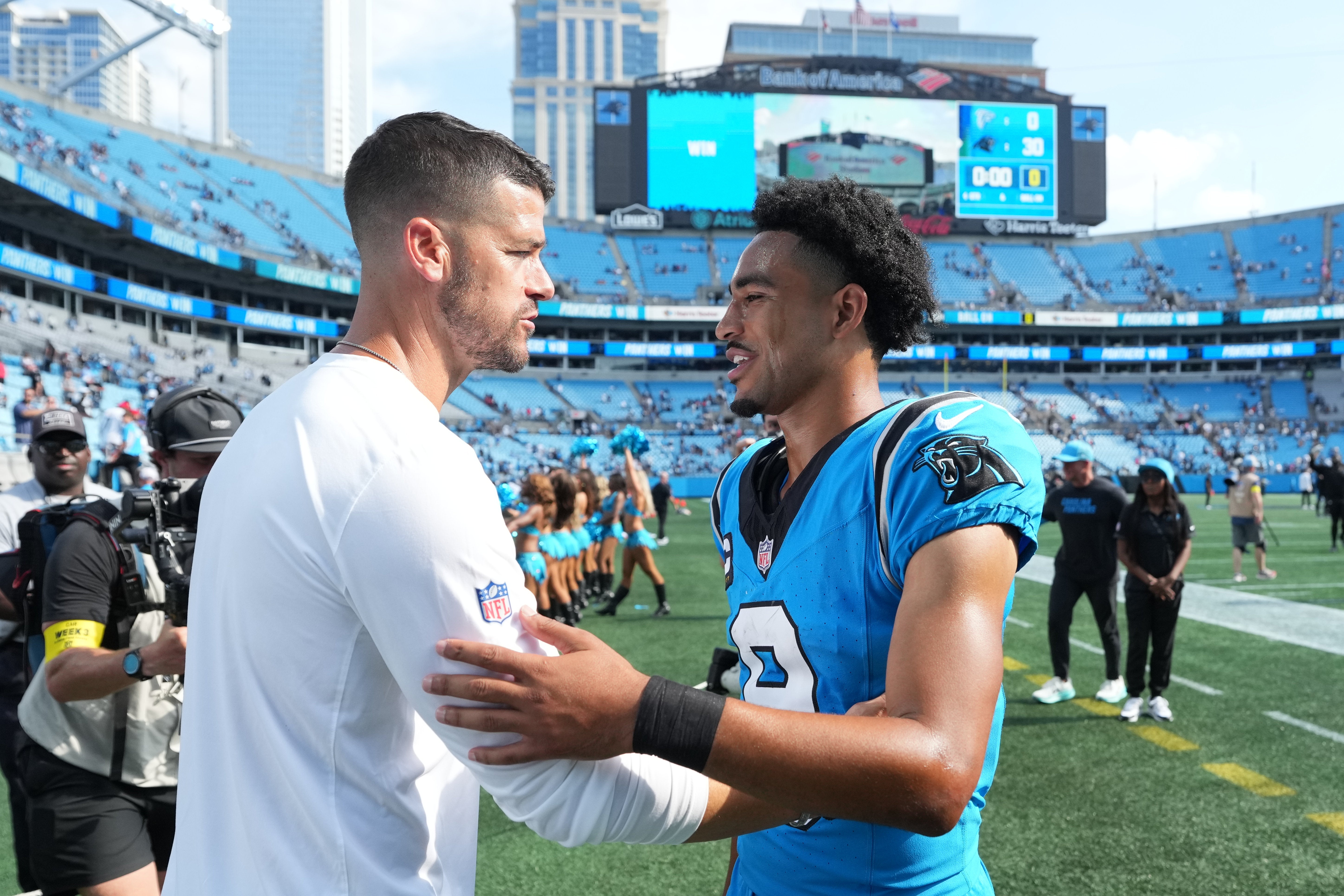 Sep 21, 2025; Charlotte, North Carolina, USA; Carolina Panthers head coach Dave Canales with quarterback Bryce Young (9) after the game at Bank of America Stadium.