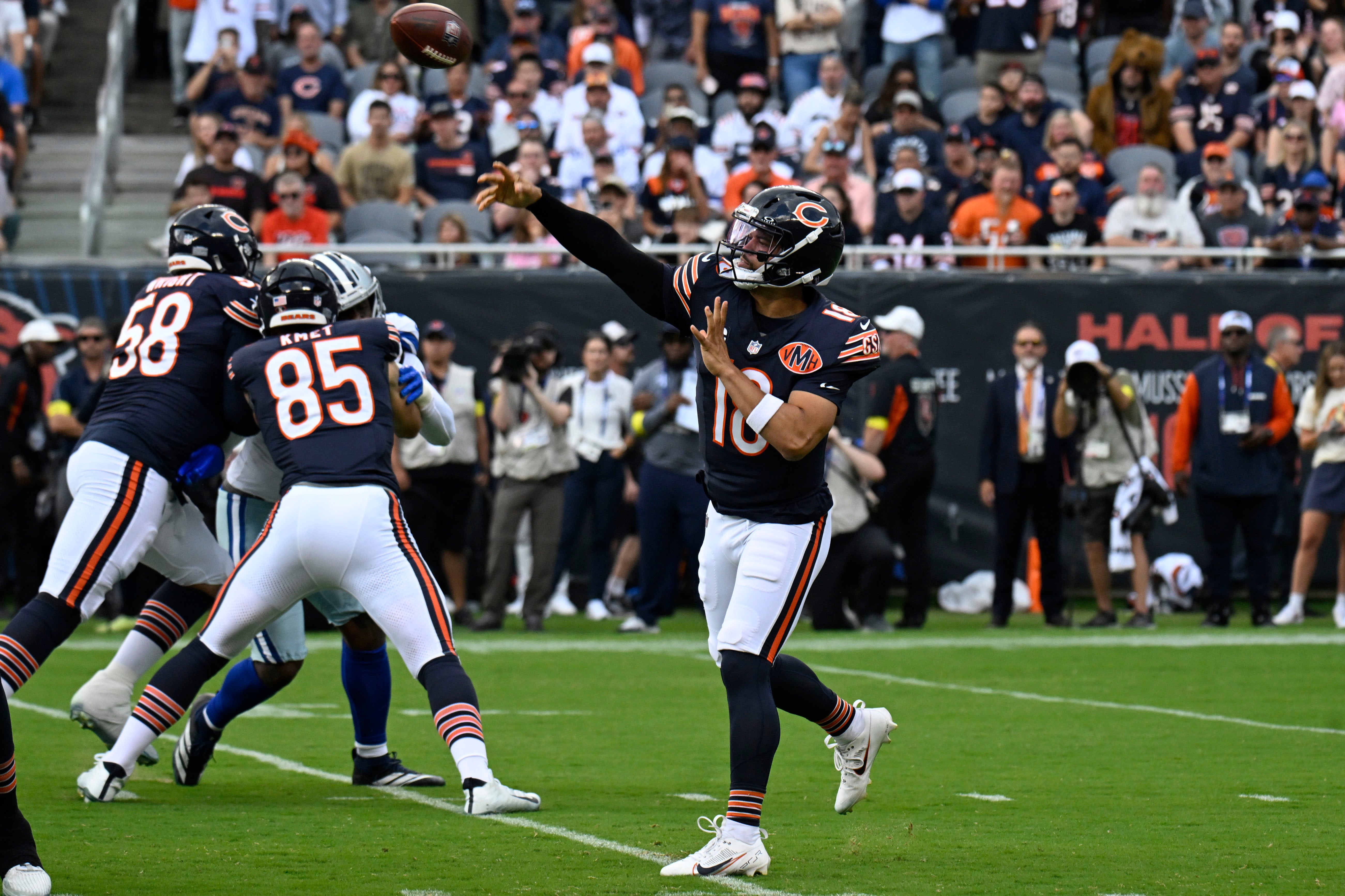 Sep 21, 2025; Chicago, Illinois, USA; Chicago Bears quarterback Caleb Williams (18) drops back to pass against the Dallas Cowboys during the first half at Soldier Field.