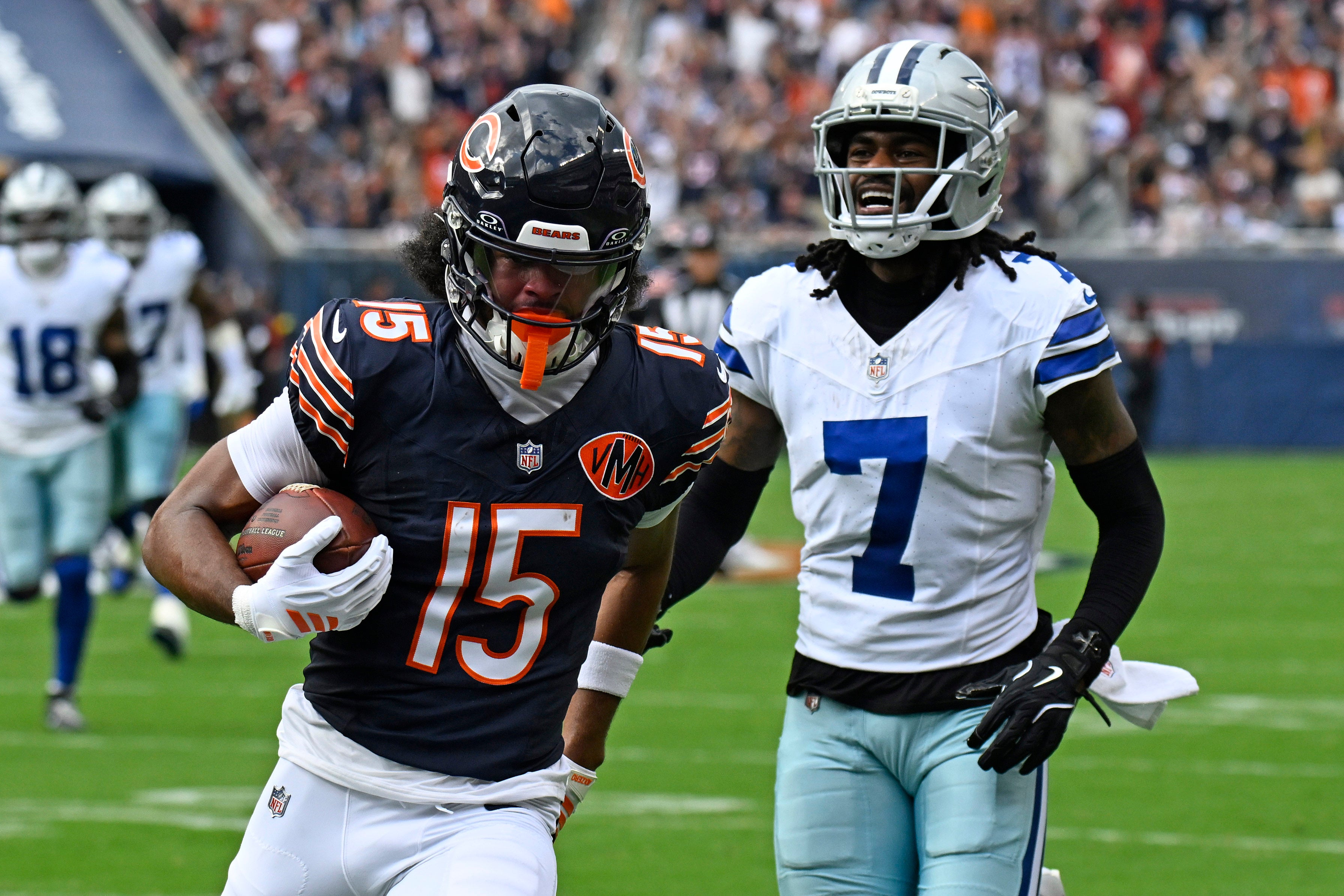 Sep 21, 2025; Chicago, Illinois, USA; Chicago Bears wide receiver Rome Odunze (15) catches a touchdown pass against Dallas Cowboys wide receiver Traeshon Holden (7) during the first half at Soldier Field.
