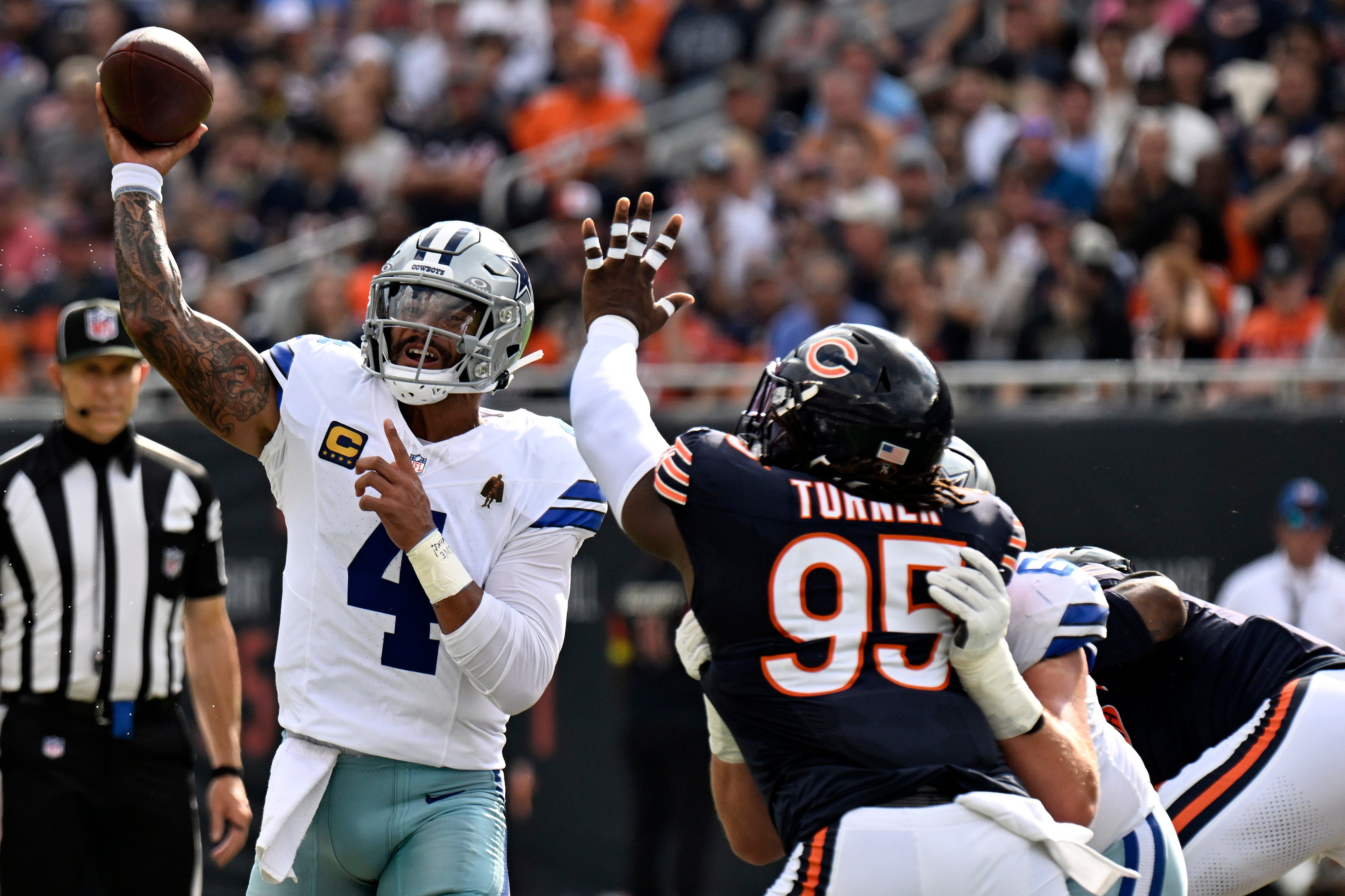 Sep 21, 2025; Chicago, Illinois, USA; Dallas Cowboys quarterback Dak Prescott (4) drops back to pass against the Chicago Bears during the first half at Soldier Field.