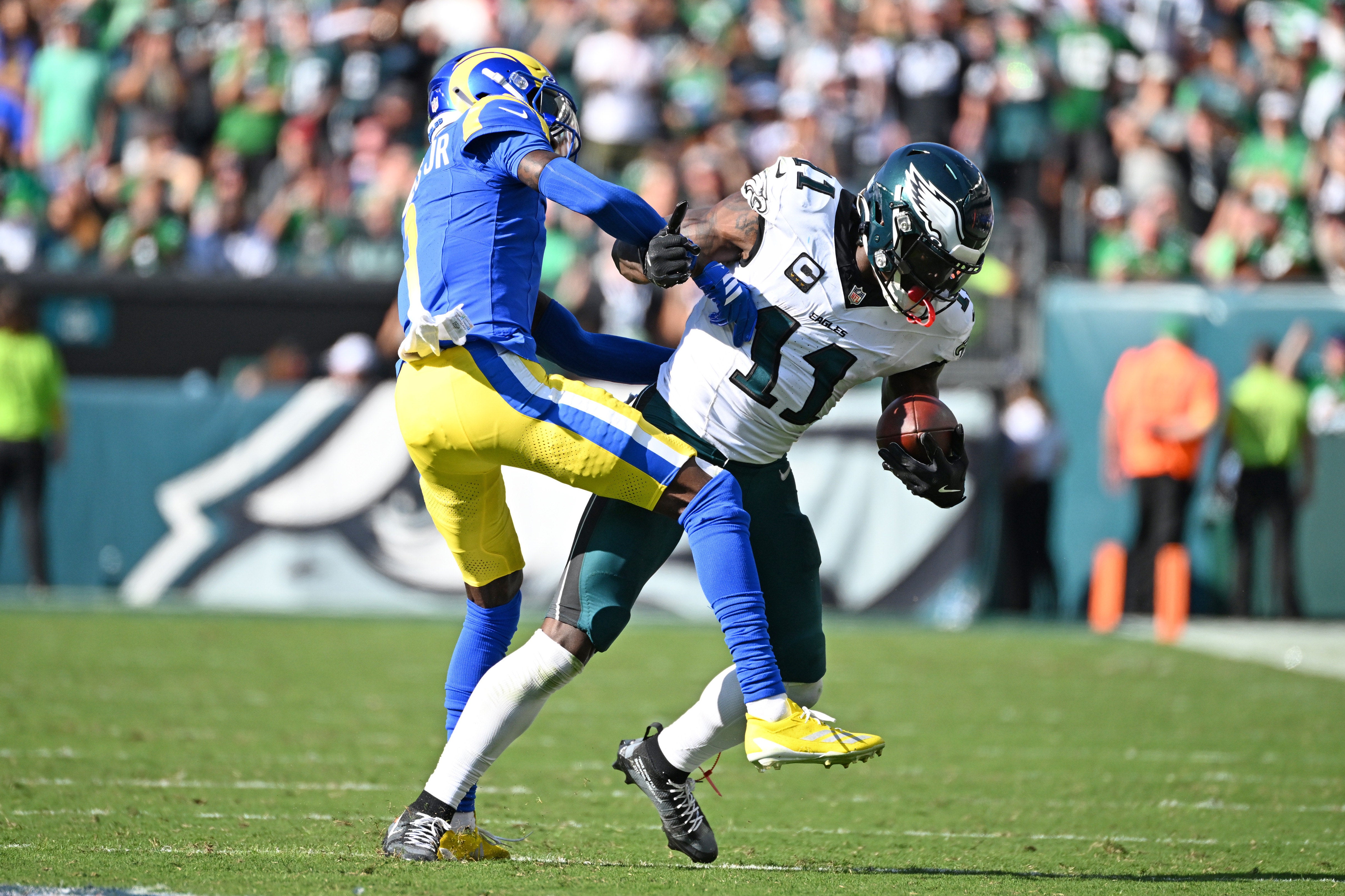 Sep 21, 2025; Philadelphia, Pennsylvania, USA; Philadelphia Eagles wide receiver AJ. Brown (11) breaks away from Los Angeles Rams cornerback Emmanuel Forbes, Jr (1) during the fourth quarter at Lincoln Financial Field.