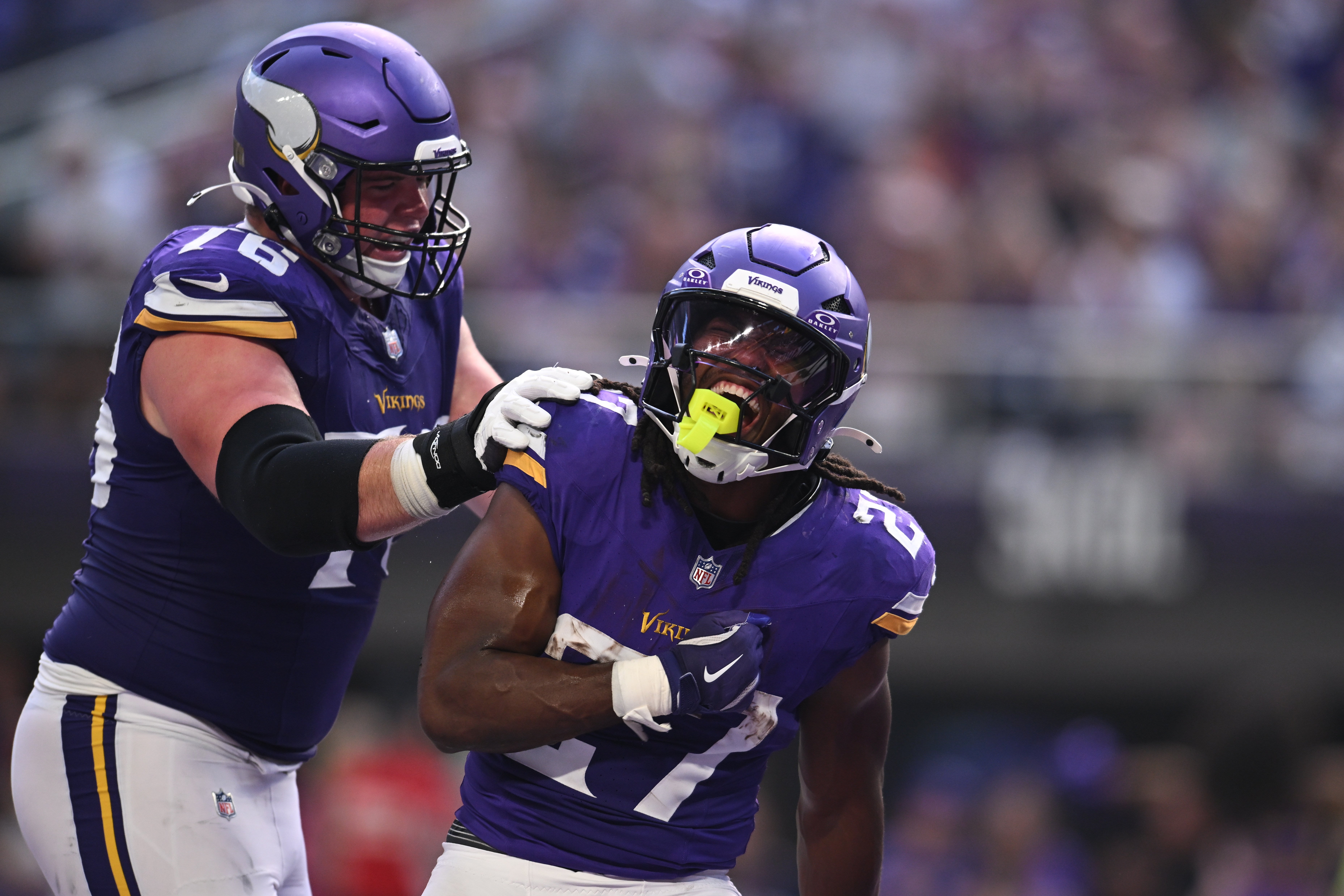 Sep 21, 2025; Minneapolis, Minnesota, USA; Minnesota Vikings running back Jordan Mason (27) reacts after scoring with guard Will Fries (76) against the Cincinnati Bengals during the second half at U.S. Bank Stadium.