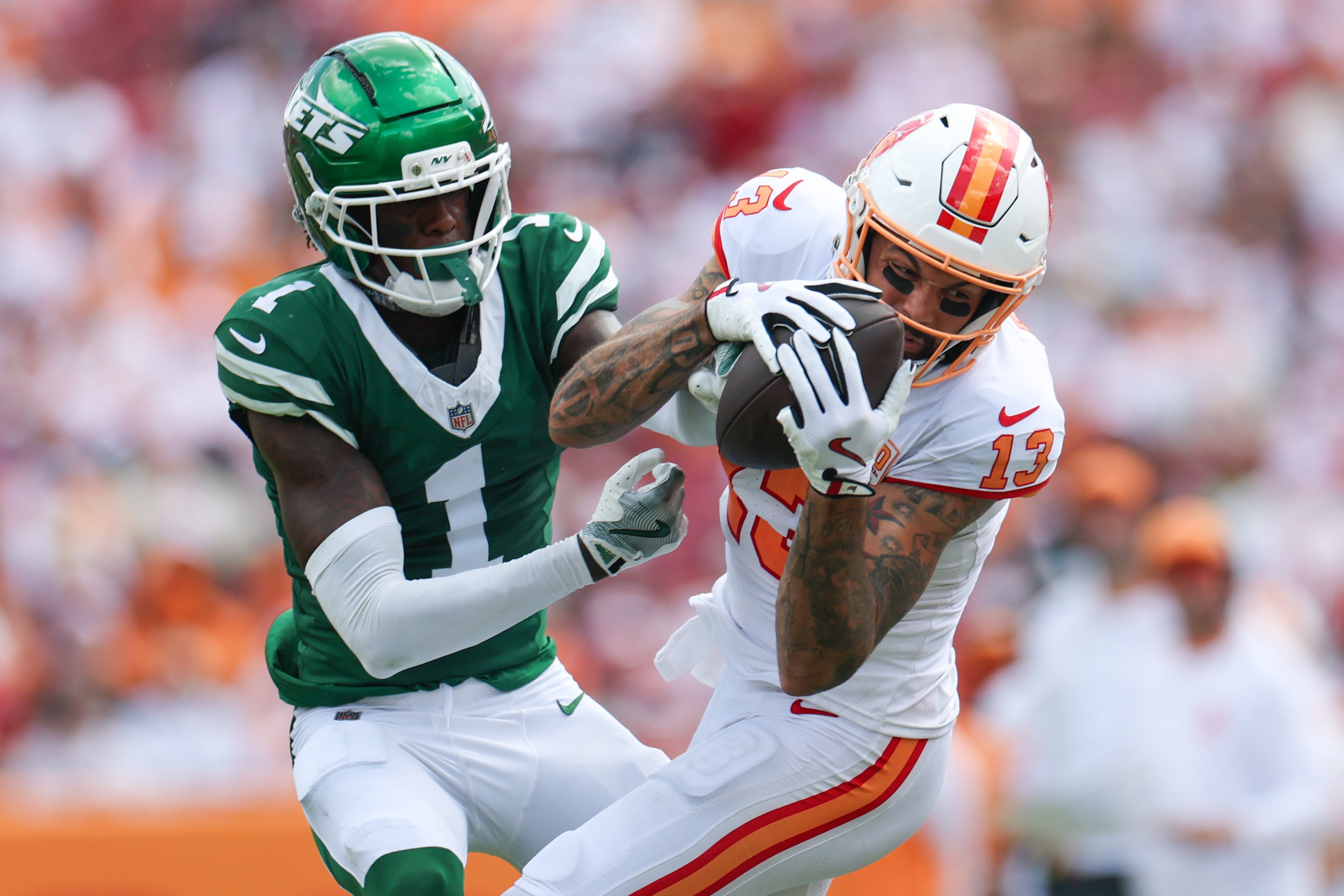 Sep 21, 2025; Tampa, Florida, USA; Tampa Bay Buccaneers wide receiver Mike Evans (13) catches pass defended boy New York Jets cornerback Sauce Gardner (1) in the third quarter at Raymond James Stadium.