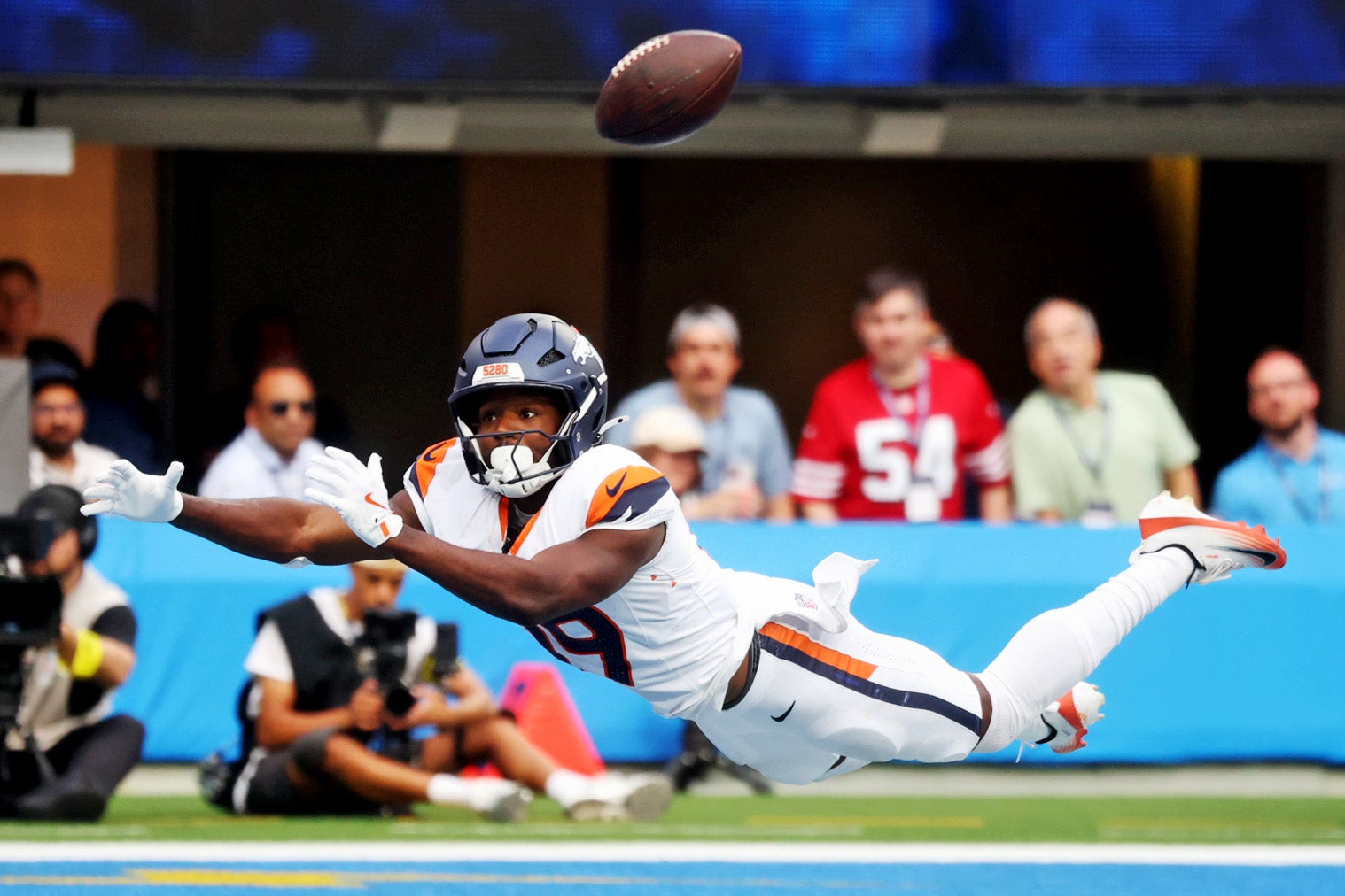 Sep 21, 2025; Inglewood, California, USA; Denver Broncos wide receiver Marvin Mims Jr. (19) scores a touchdown during the first half against the Los Angeles Chargers at SoFi Stadium.