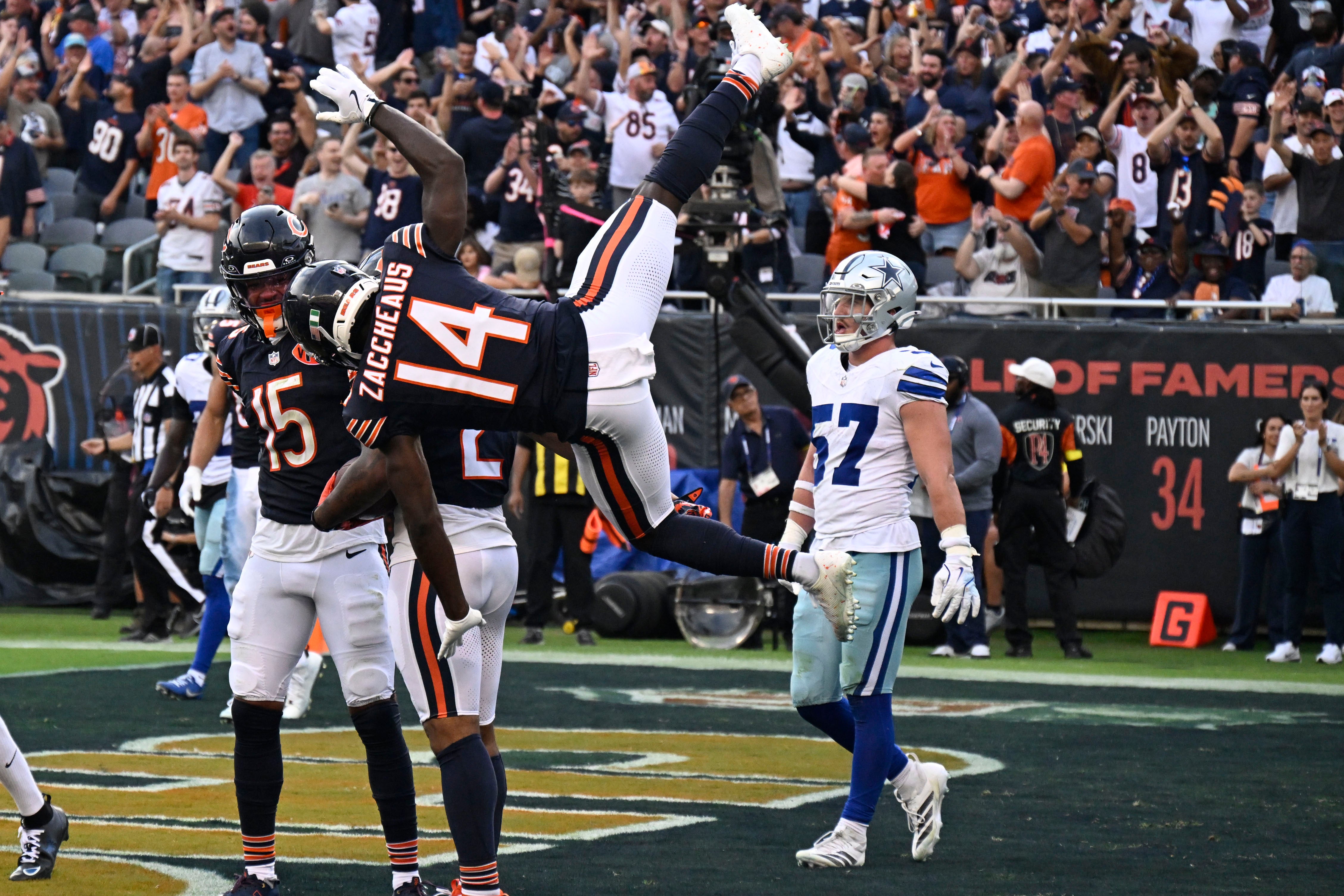 Sep 21, 2025; Chicago, Illinois, USA; Chicago Bears wide receiver DJ Moore (2) reacts after scoring a touchdown with wide receiver Olamide Zaccheaus (14) against the Dallas Cowboys during the second half at Soldier Field.