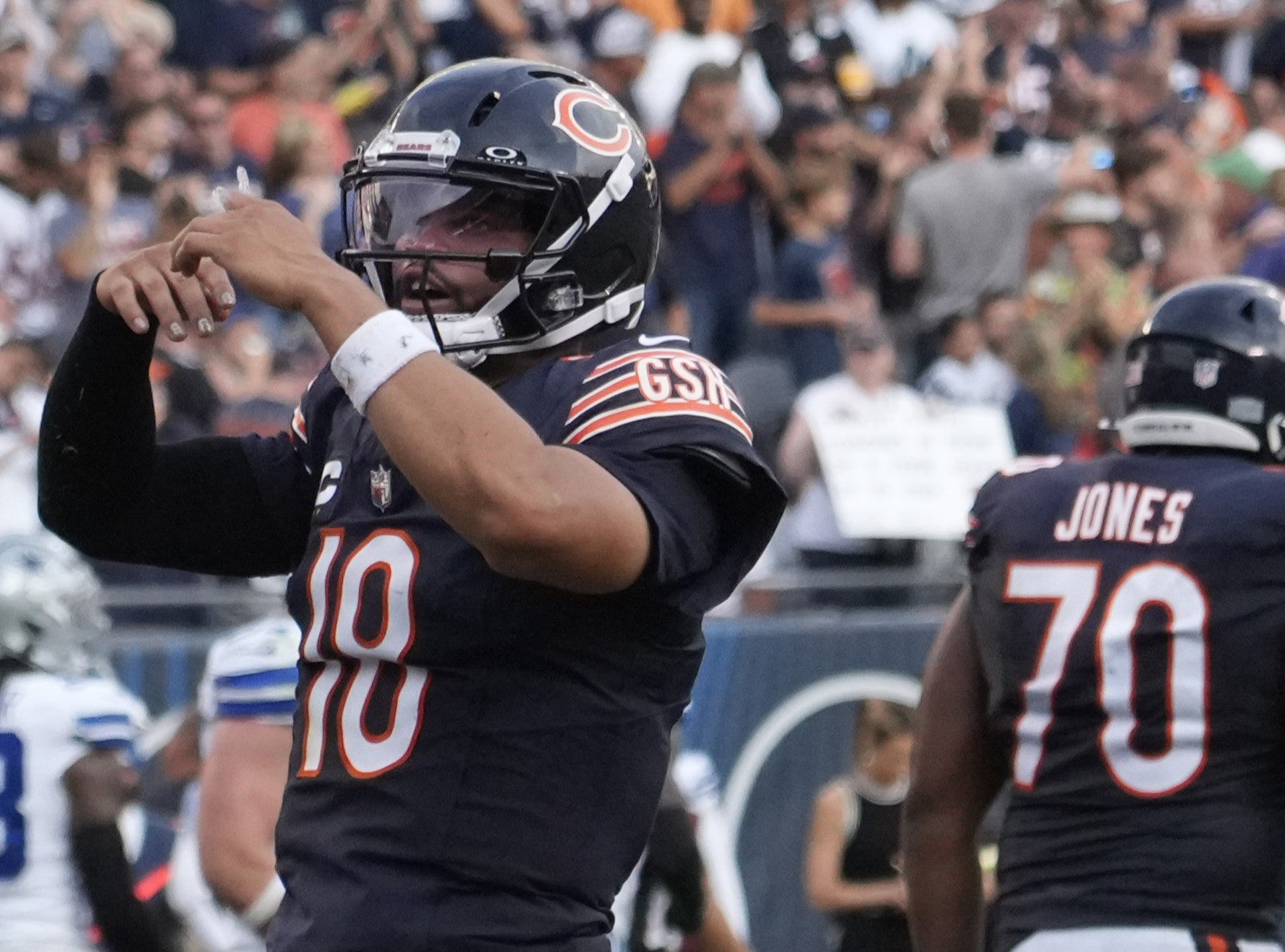 Sep 21, 2025; Chicago, Illinois, USA; Chicago Bears quarterback Caleb Williams (18) gestures after throwing a touchdown against the Dallas Cowboys during the second half at Soldier Field.