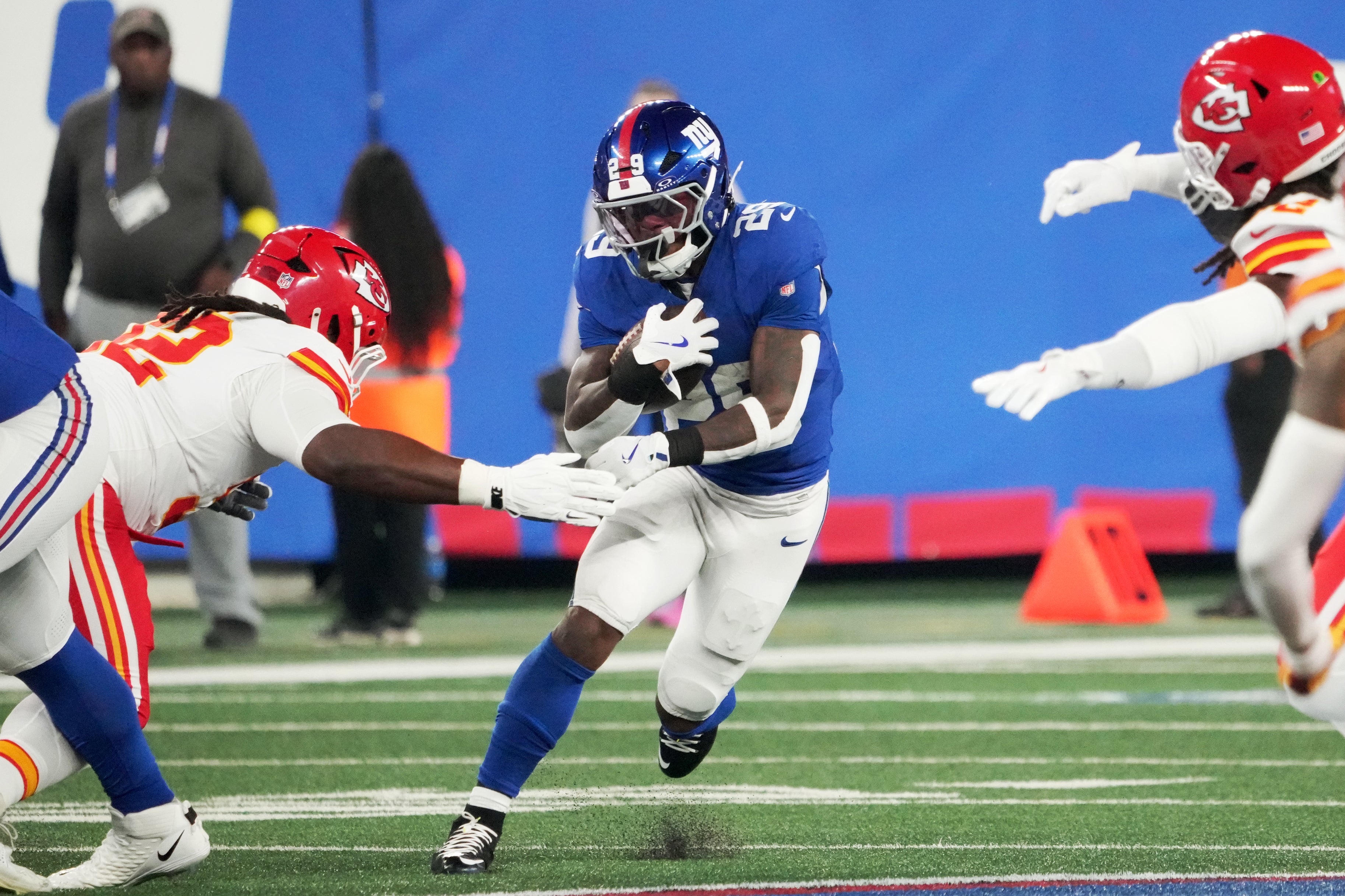 Sep 21, 2025; East Rutherford, New Jersey, USA; New York Giants running back Tyrone Tracy Jr. (29) runs against Kansas City Chiefs linebacker Nick Bolton (32) in the first quarter at MetLife Stadium.