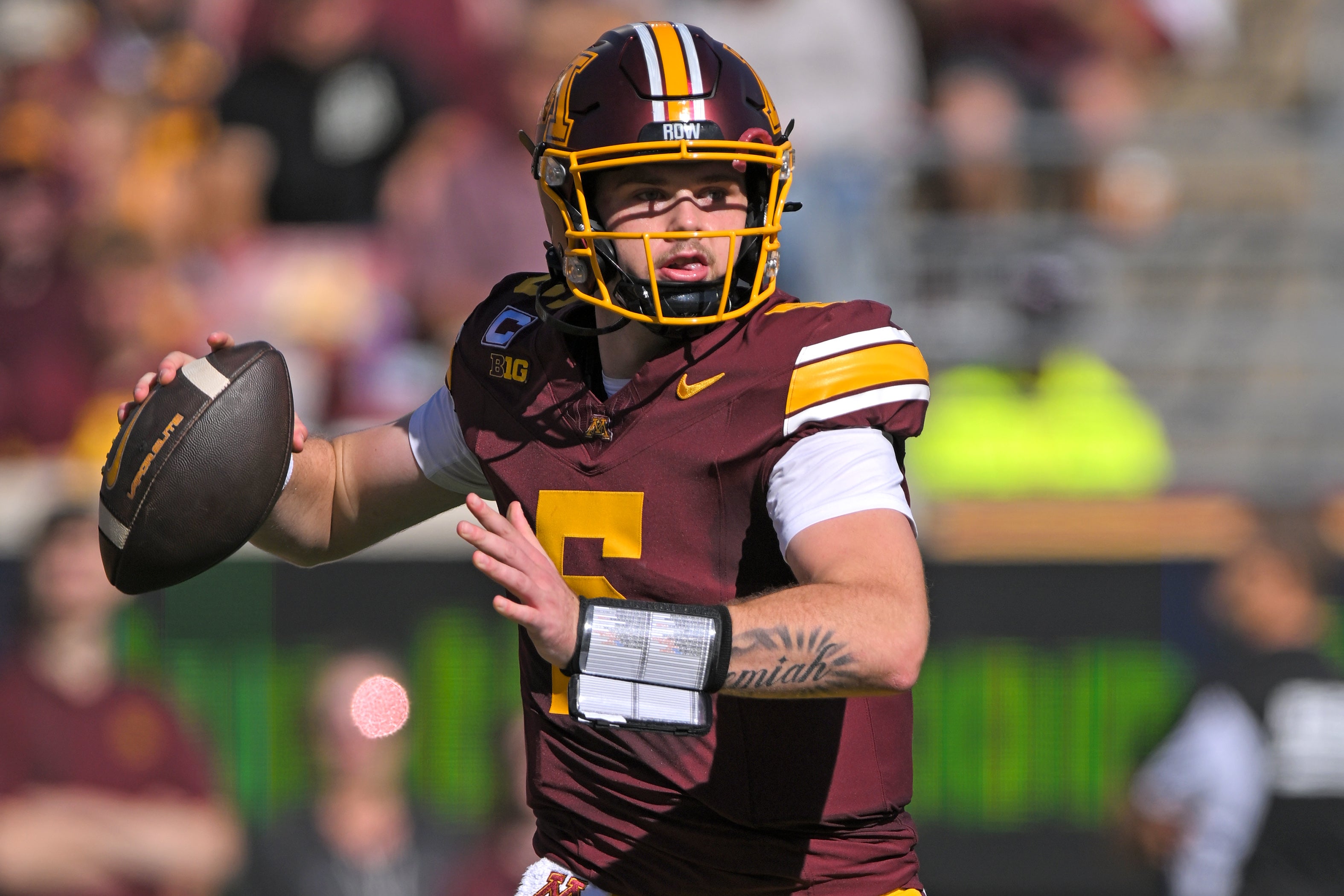 Sep 27, 2025; Minneapolis, Minnesota, USA; Minnesota Golden Gophers quarterback Drake Lindsey (5) makes a pass against Rutgers Scarlet Knights during the first quarter at Huntington Bank Stadium.