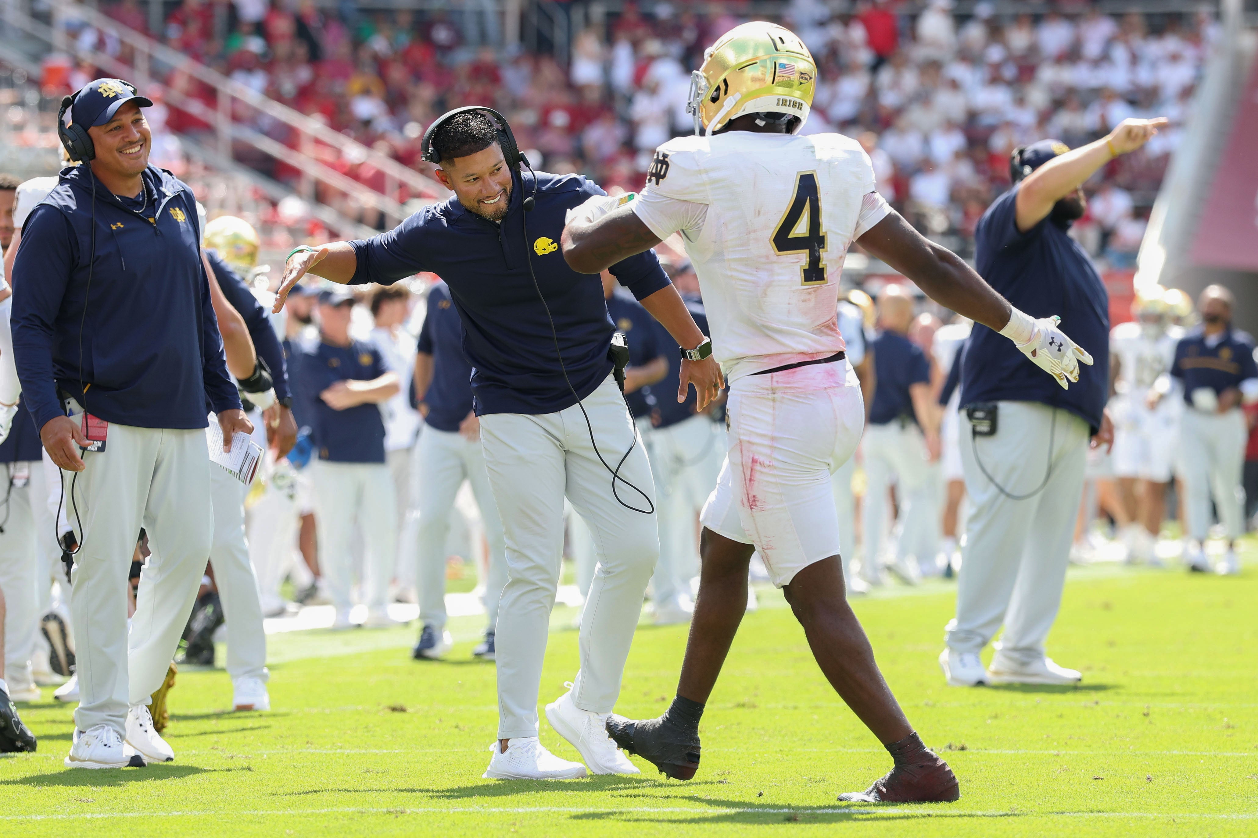 Sep 27, 2025; Fayetteville, Arkansas, USA; Notre Dame Fighting Irish head coach Marcus Freeman celebrates with running back Jeremiyah Love (4) after a touchdown in the second quarter against the Arkansas Razorbacks at Donald W. Reynolds Razorback Stadium. Mandatory Credit: Nelson Chenault-Imagn Images
