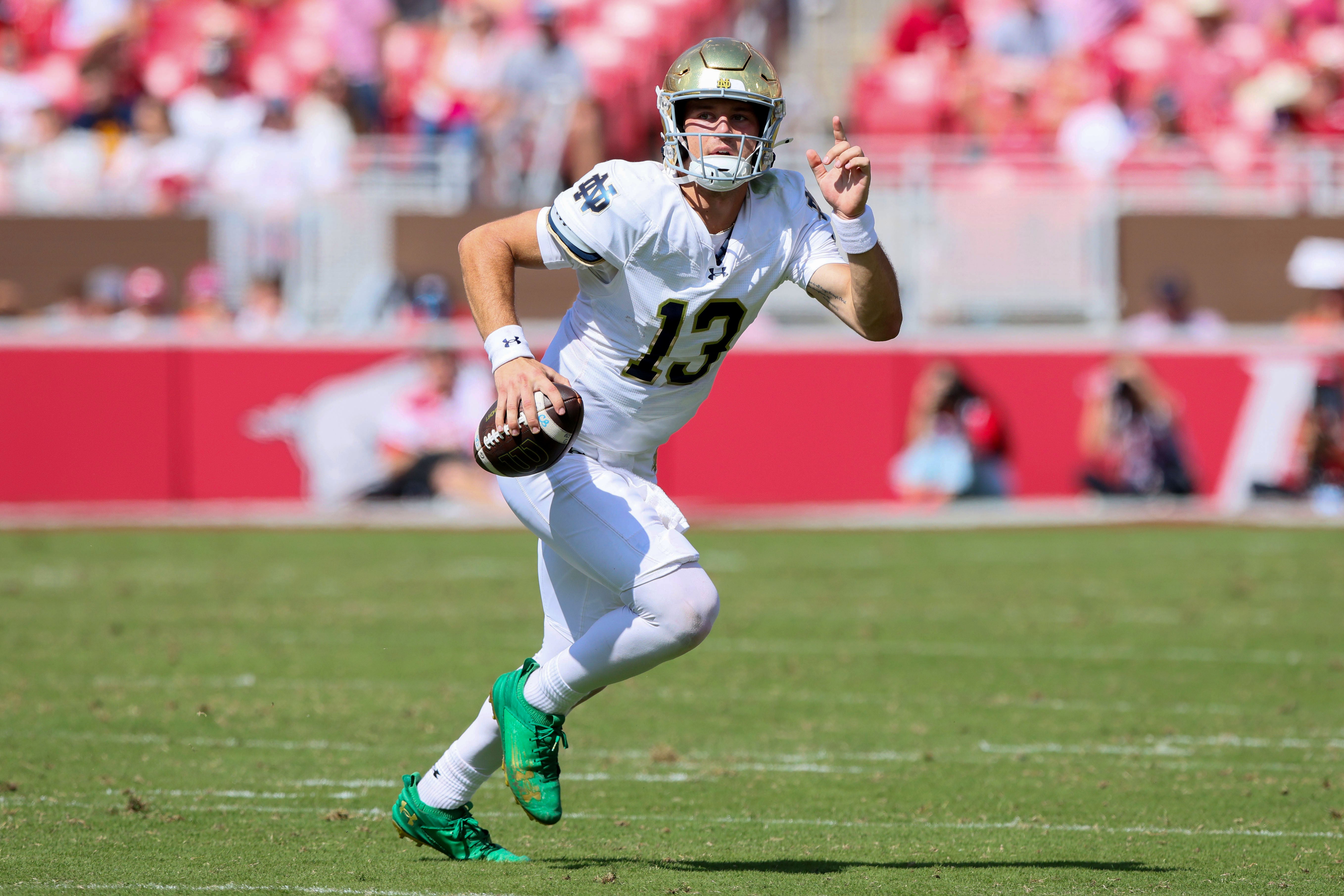 Sep 27, 2025; Fayetteville, Arkansas, USA; Notre Dame Fighting Irish quarterback CJ Carr (13) looks to pass during the third quarter against the Arkansas Razorbacks at Donald W. Reynolds Razorback Stadium. Notre Dame won 56-13. Mandatory Credit: Nelson Chenault-Imagn Images