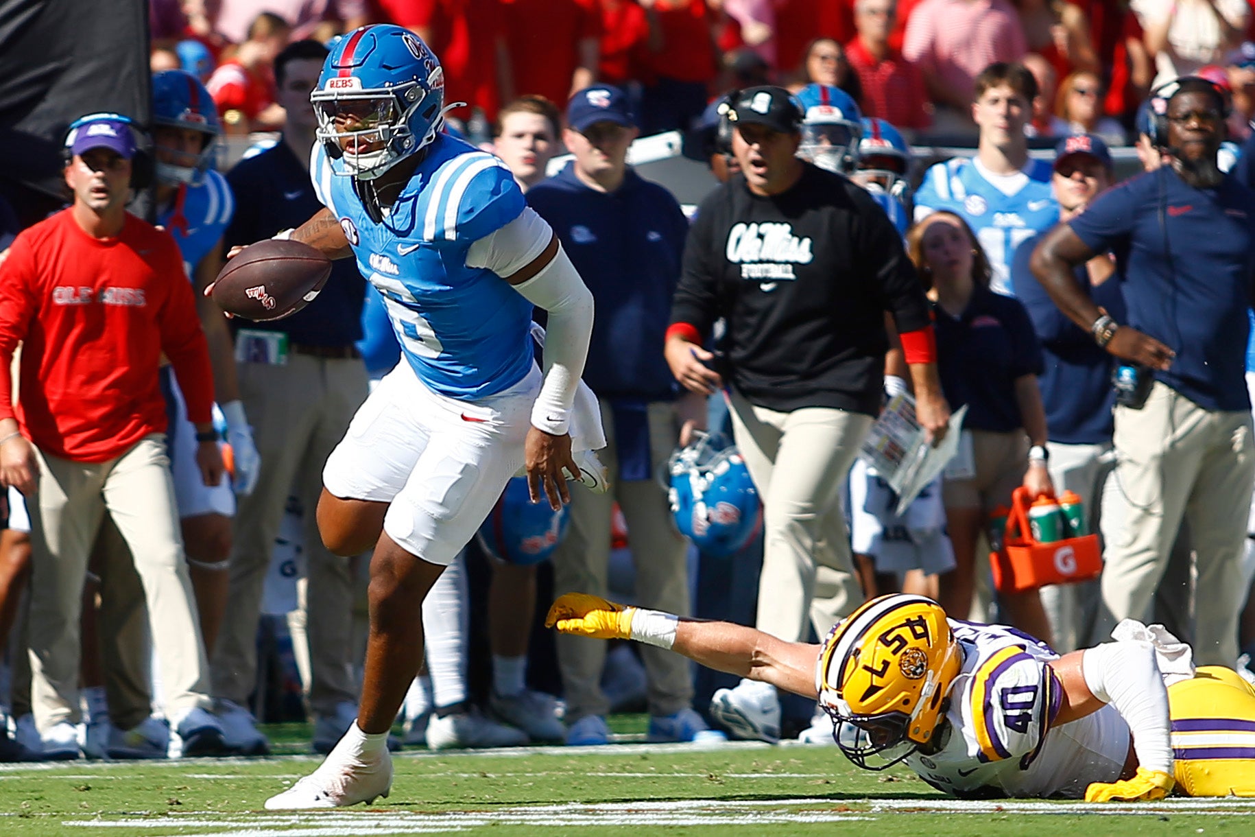 Sep 27, 2025; Oxford, Mississippi, USA; Mississippi Rebels quarterback Trinidad Chambliss (6) breaks a tackle attempt by LSU Tigers linebacker Whit Weeks (40) during the first quarter at Vaught-Hemingway Stadium.