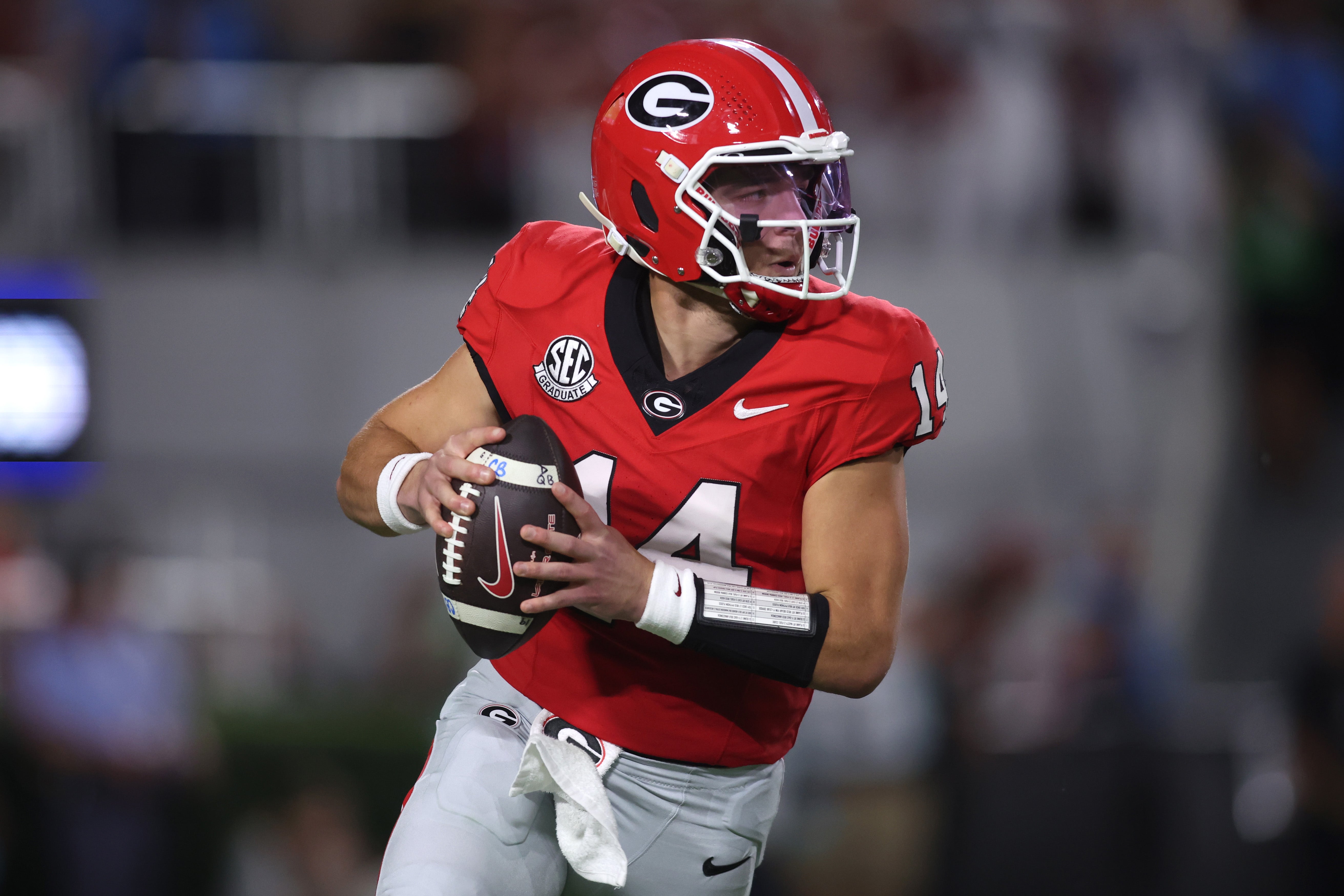 Georgia Bulldogs quarterback Gunner Stockton (14) looks to pass against the Alabama Crimson Tide in the first half at Sanford Stadium.