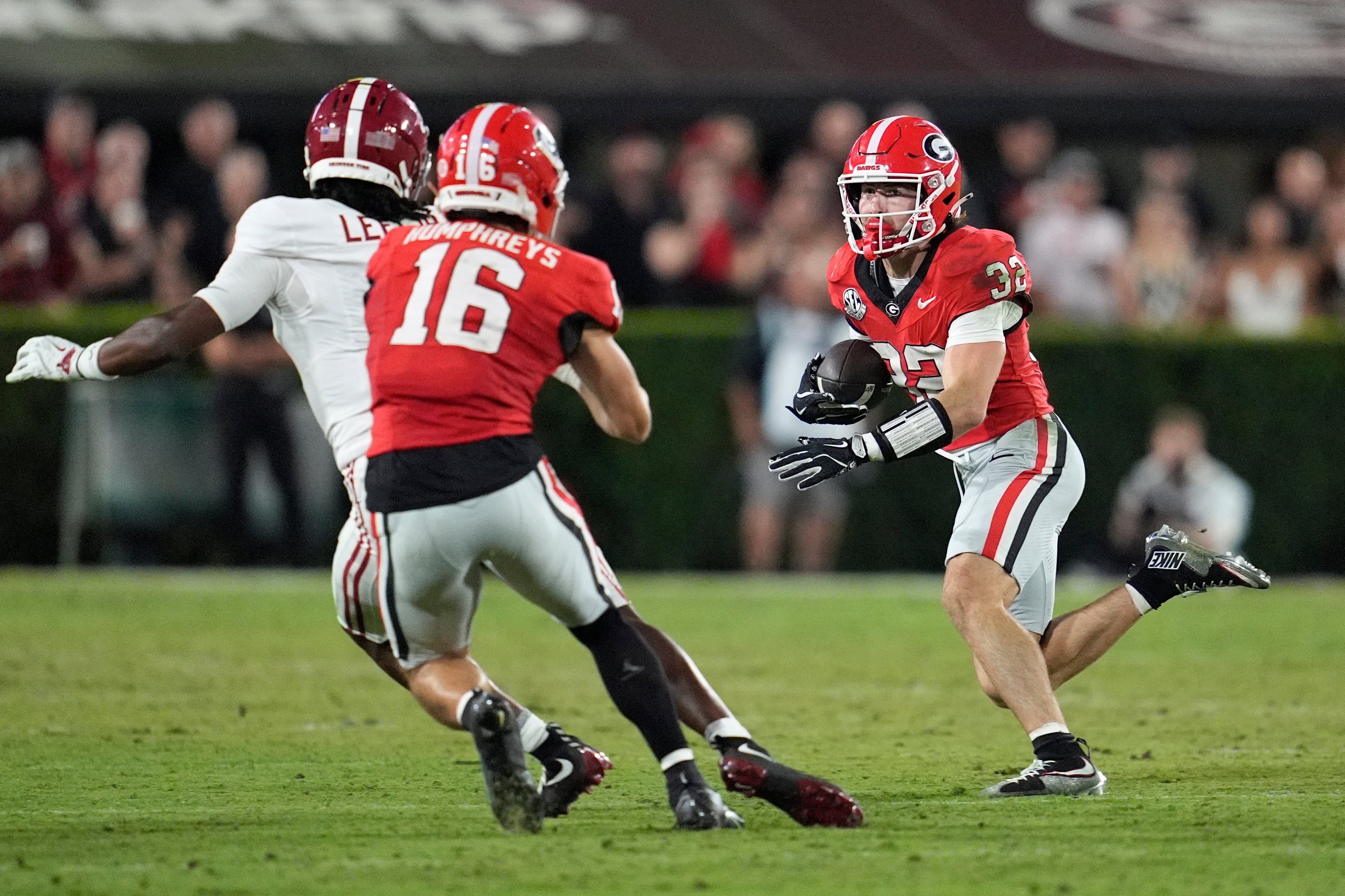 Georgia Bulldogs running back Cash Jones (32) runs against the Alabama Crimson Tide in the second half at Sanford Stadium.