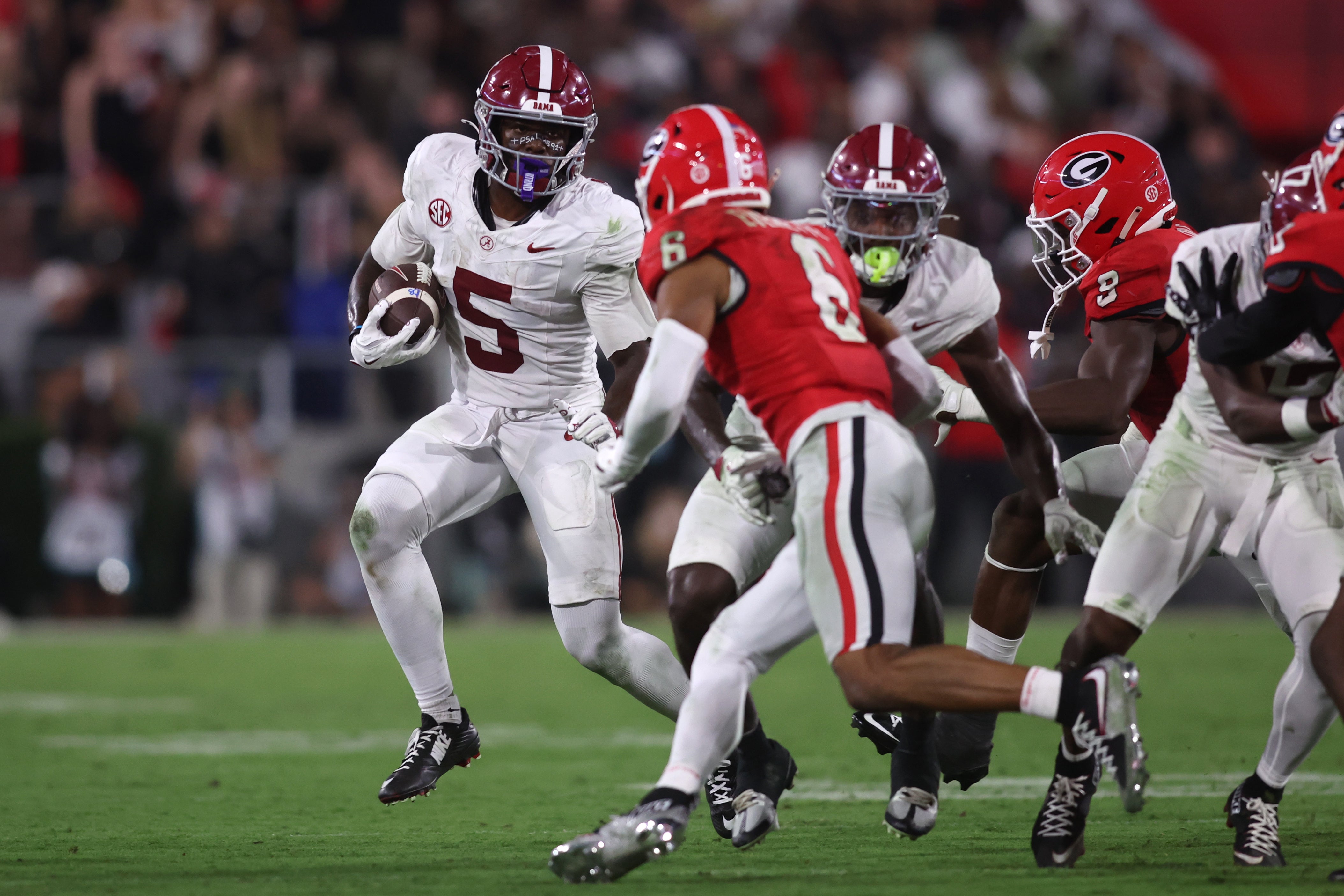Alabama Crimson Tide wide receiver Germie Bernard (5) runs against Georgia Bulldogs defensive back Daylen Everette (6) in the second half at Sanford Stadium.