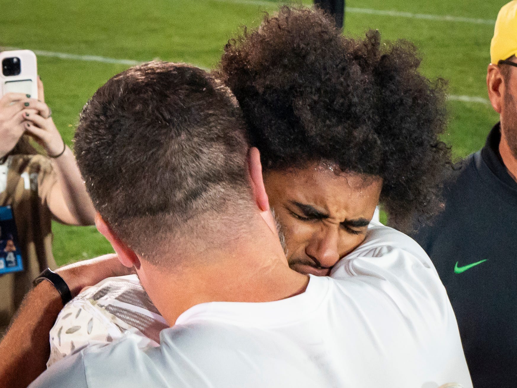Oregon head coach Dan Lanning, left, embraces Oregon quarterback Dante Moore after the Ducks’ win as the Oregon Ducks face the Penn State Nittany Lions on Sept. 27, 2025, at Beaver Stadium in University Park, Pennsylvania.